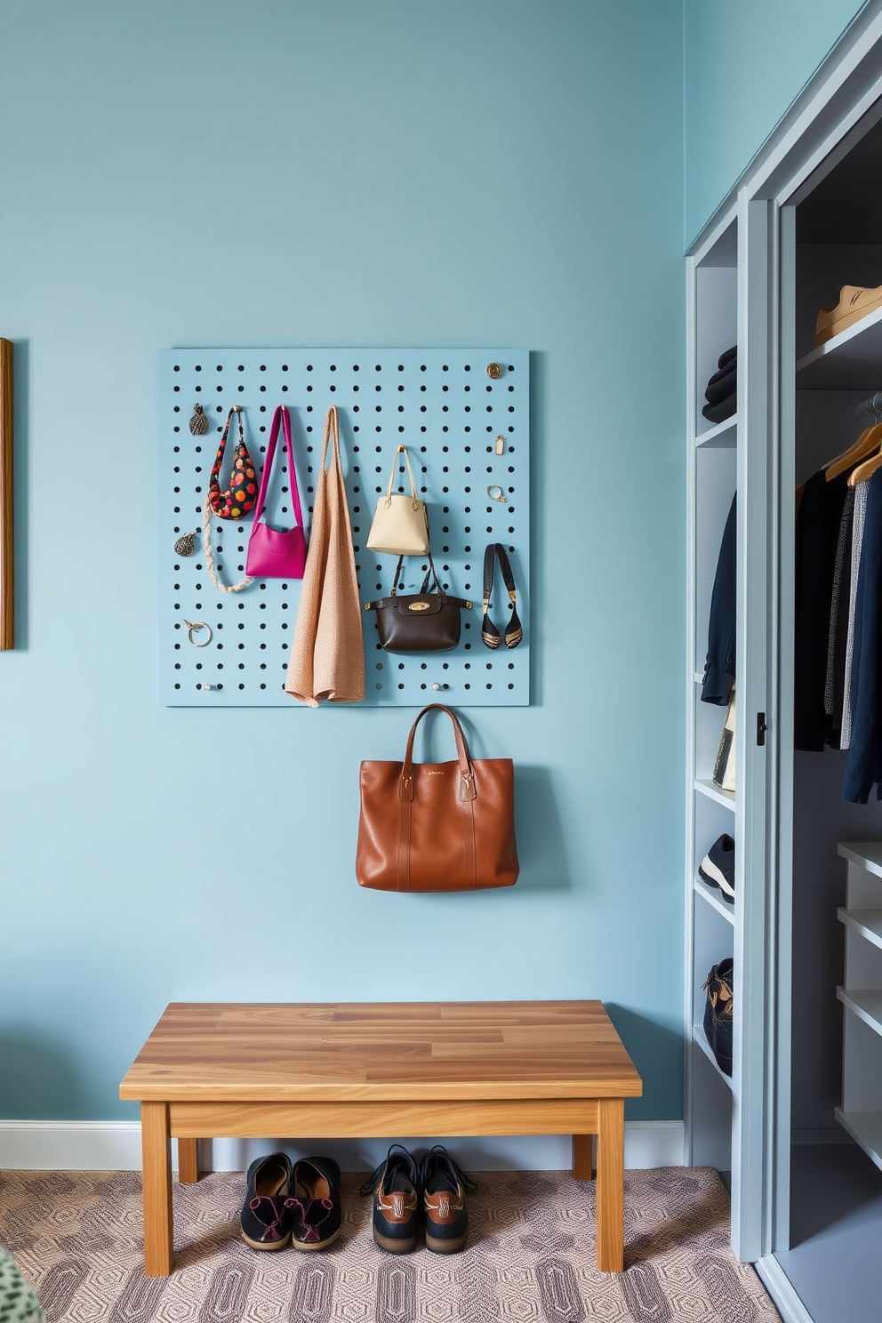 A powder blue pegboard adorns the wall, providing a stylish and functional space for displaying accessories. Below the pegboard, a sleek wooden bench offers a comfortable spot for putting on shoes or organizing belongings. The walk-in closet features custom shelving and hanging space, maximizing storage while maintaining an elegant aesthetic. Soft lighting highlights the carefully curated accessories, creating a welcoming and organized environment.