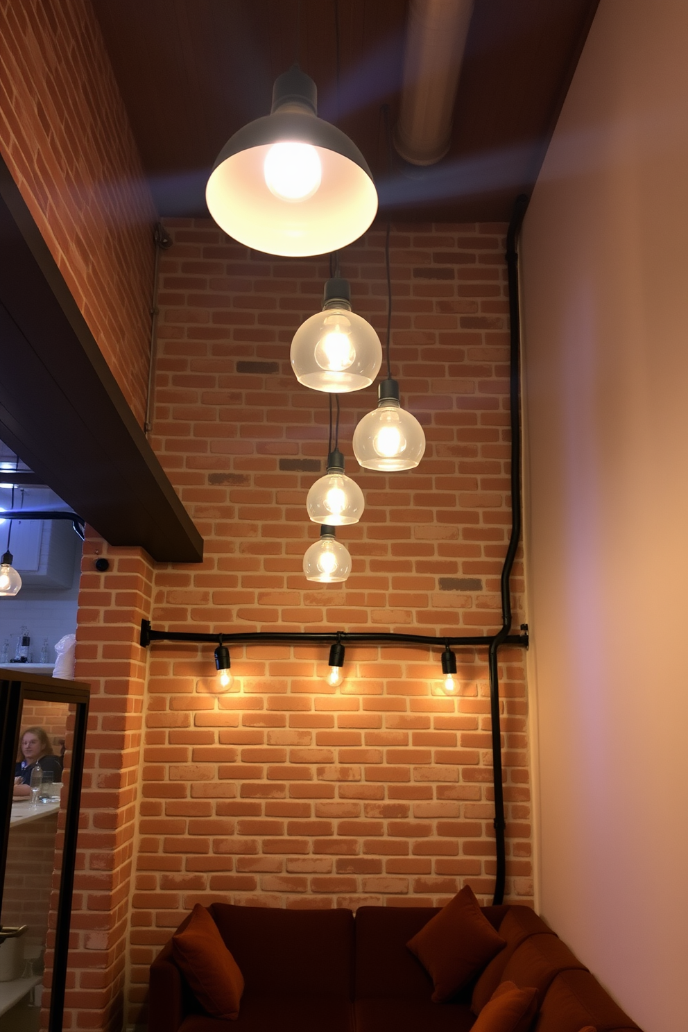 Bright pendant lights hang from the ceiling, casting a warm glow over the exposed brick walls. The space features a cozy seating area with plush furniture, creating an inviting atmosphere in the basement.