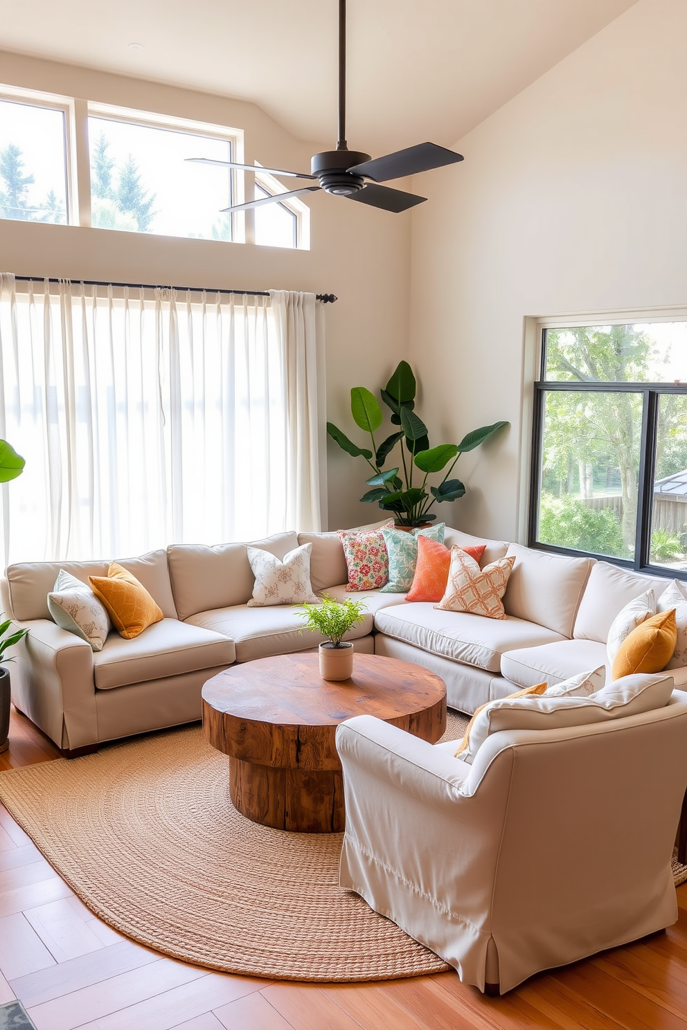 A cozy California living room features a large, plush sectional sofa in a soft beige fabric, adorned with colorful throw pillows. A round coffee table made of reclaimed wood sits in the center, surrounded by two oversized armchairs that invite relaxation. Natural light floods the space through large windows draped with sheer white curtains, enhancing the airy feel. Potted plants in the corners add a touch of greenery, while a woven area rug anchors the seating area in warm tones.