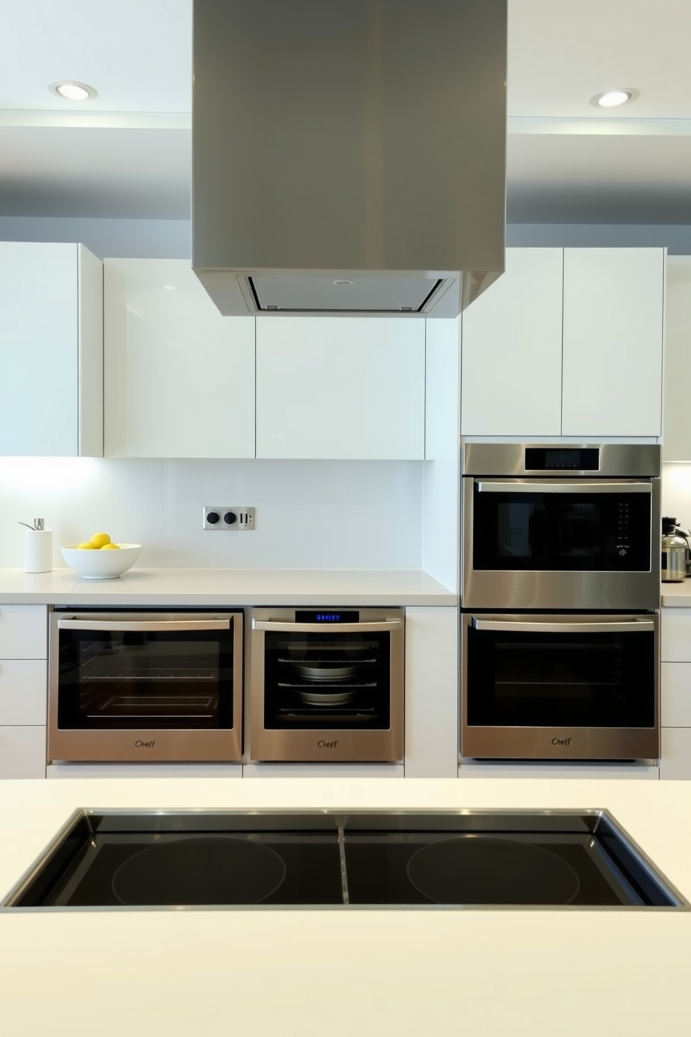 A modern chef's kitchen featuring soft-close drawers for quiet operation and seamless functionality. The space includes a large central island with bar seating, surrounded by high-end stainless steel appliances and custom cabinetry.