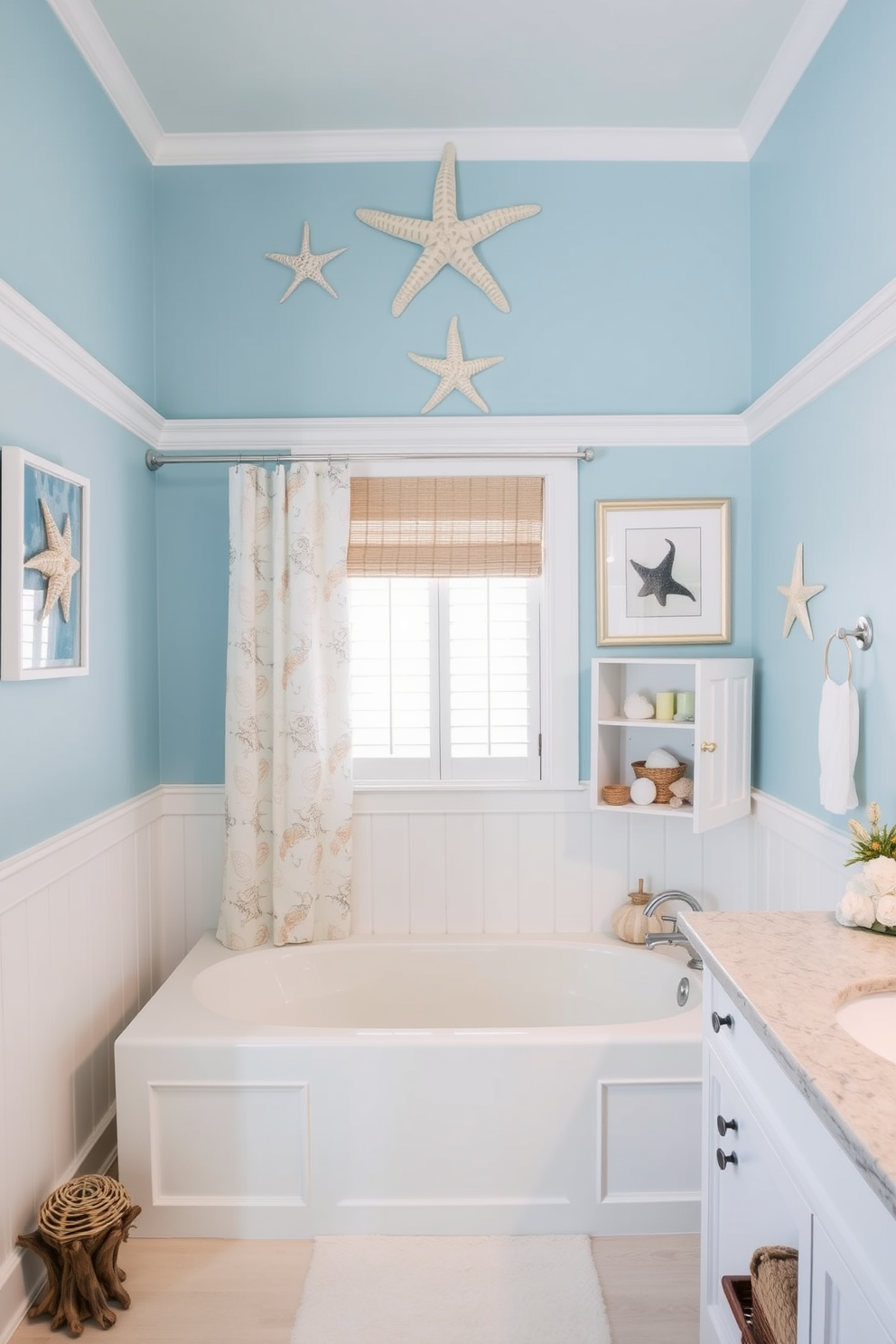 A coastal bathroom design featuring starfish and seashell decorative accents. The walls are painted in a soft ocean blue, complemented by white wainscoting and driftwood accents throughout the space. A large soaking tub sits in the center, adorned with a seashell-themed shower curtain. Nautical-themed artwork hangs on the walls, and a collection of starfish is displayed on a shelf above the vanity.