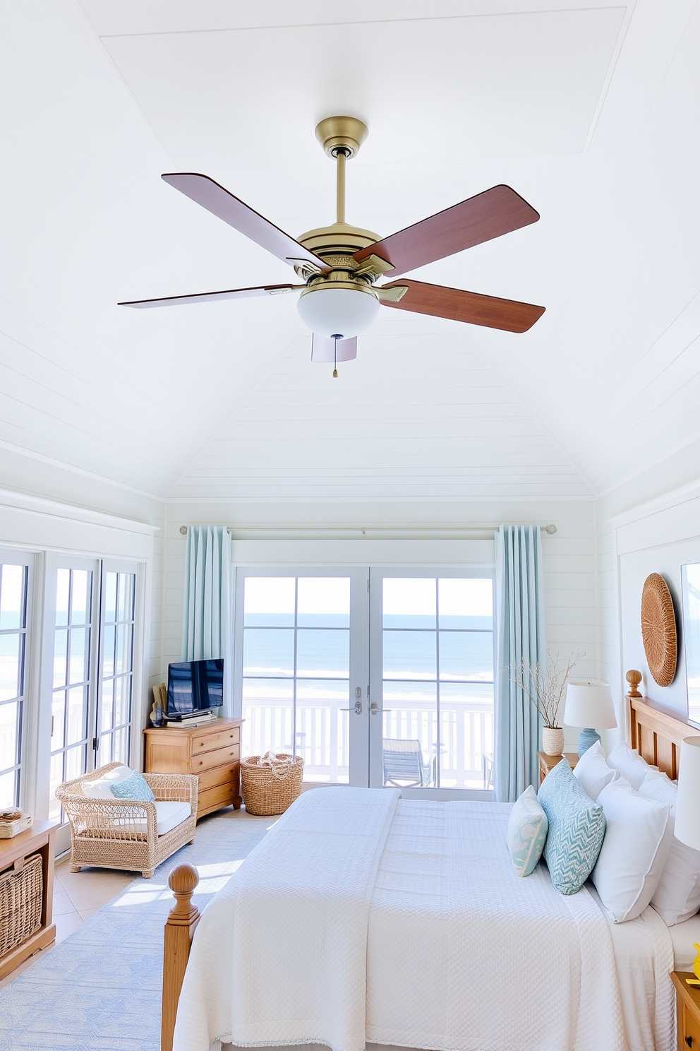 A stylish ceiling fan with a sleek design hangs from a white shiplap ceiling, providing a refreshing airflow in the room. The coastal bedroom features soft blue and white tones, accented by natural wood furniture and light, airy fabrics. Large windows allow abundant natural light to fill the space, showcasing the serene ocean view outside. Accessories like woven baskets and seashell decorations enhance the coastal theme, creating a relaxing retreat.