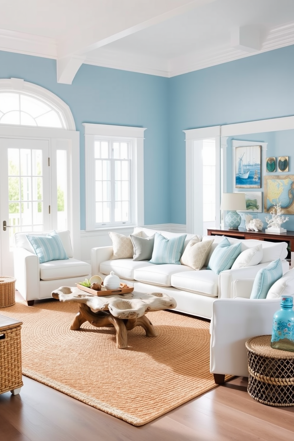 A bright and airy coastal living room features light blue walls complemented by crisp white trim. The space is filled with natural light, showcasing a comfortable white sofa adorned with soft blue and beige cushions. A large woven area rug anchors the seating area, while a driftwood coffee table adds an organic touch. Nautical-themed decor, including seashells and coral accents, enhances the coastal vibe throughout the room.