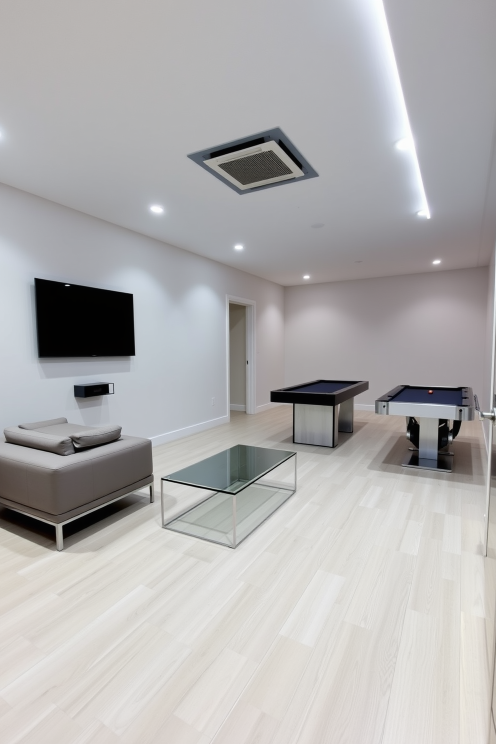 A minimalist game room featuring sleek furniture with clean lines and a neutral color palette. The room includes a low-profile sectional sofa, a glass coffee table, and a wall-mounted flat-screen TV, creating an uncluttered and modern aesthetic. The flooring is a light wood, enhancing the airy feel of the space. Accent lighting is provided by recessed lights and a few strategically placed LED strips, adding a touch of sophistication without overwhelming the simplicity of the design.