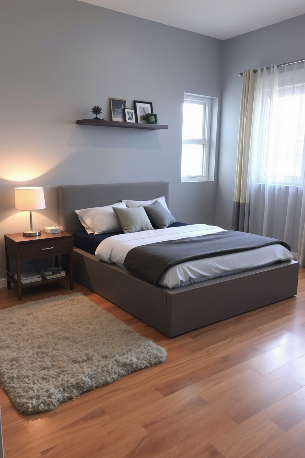 A cozy condo bedroom featuring a platform bed with built-in under-bed storage drawers. The walls are painted in a soft gray, and a plush area rug adds warmth to the hardwood floor. A stylish nightstand with a modern lamp sits beside the bed, while a floating shelf above it displays decorative items. Natural light streams in through sheer curtains, creating a bright and inviting atmosphere.