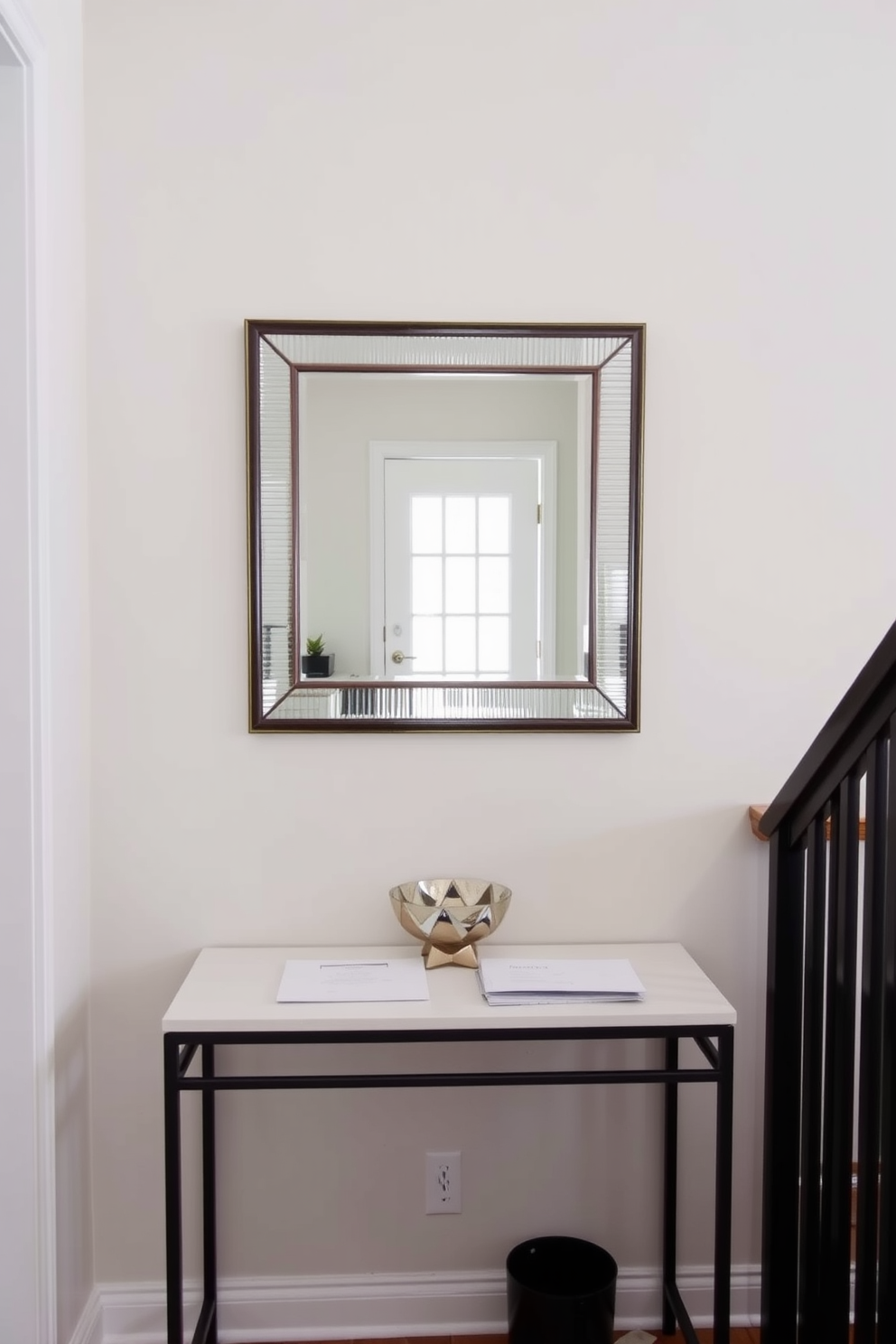 A narrow console table is positioned against the wall, providing a functional space for keys and mail. Above the table, a stylish mirror reflects the entryway, enhancing the sense of openness and light. The walls are painted in a soft neutral tone, creating a welcoming atmosphere. A small decorative bowl sits on the table, adding a touch of personality while keeping essentials organized.