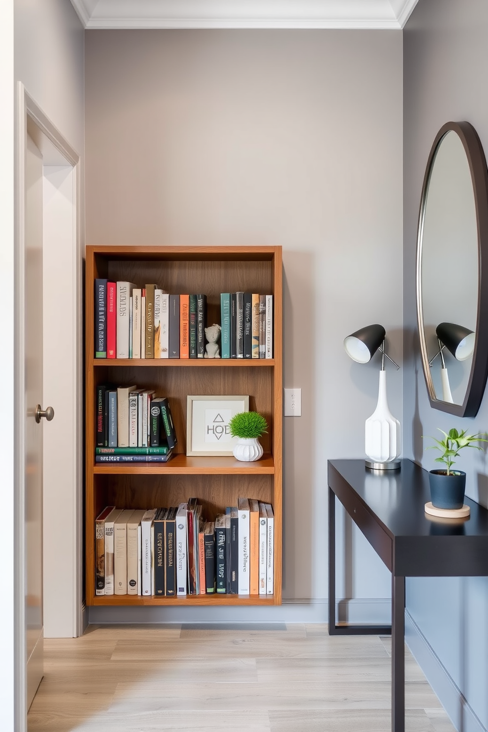 A stylish condo entryway featuring a small wooden bookshelf filled with an array of books and decorative items. The walls are painted in a soft gray hue, and a sleek console table sits against one side, adorned with a modern lamp and a small potted plant.