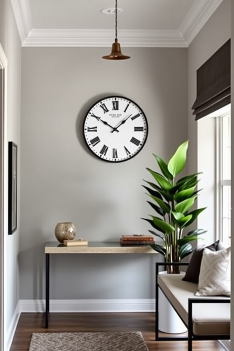 A chic entryway with a stylish clock as the focal point. The walls are painted in a soft gray hue, complemented by a sleek console table beneath the clock. To the right, a modern bench with plush cushions invites guests to sit. A large potted plant adds a touch of greenery, enhancing the welcoming atmosphere.