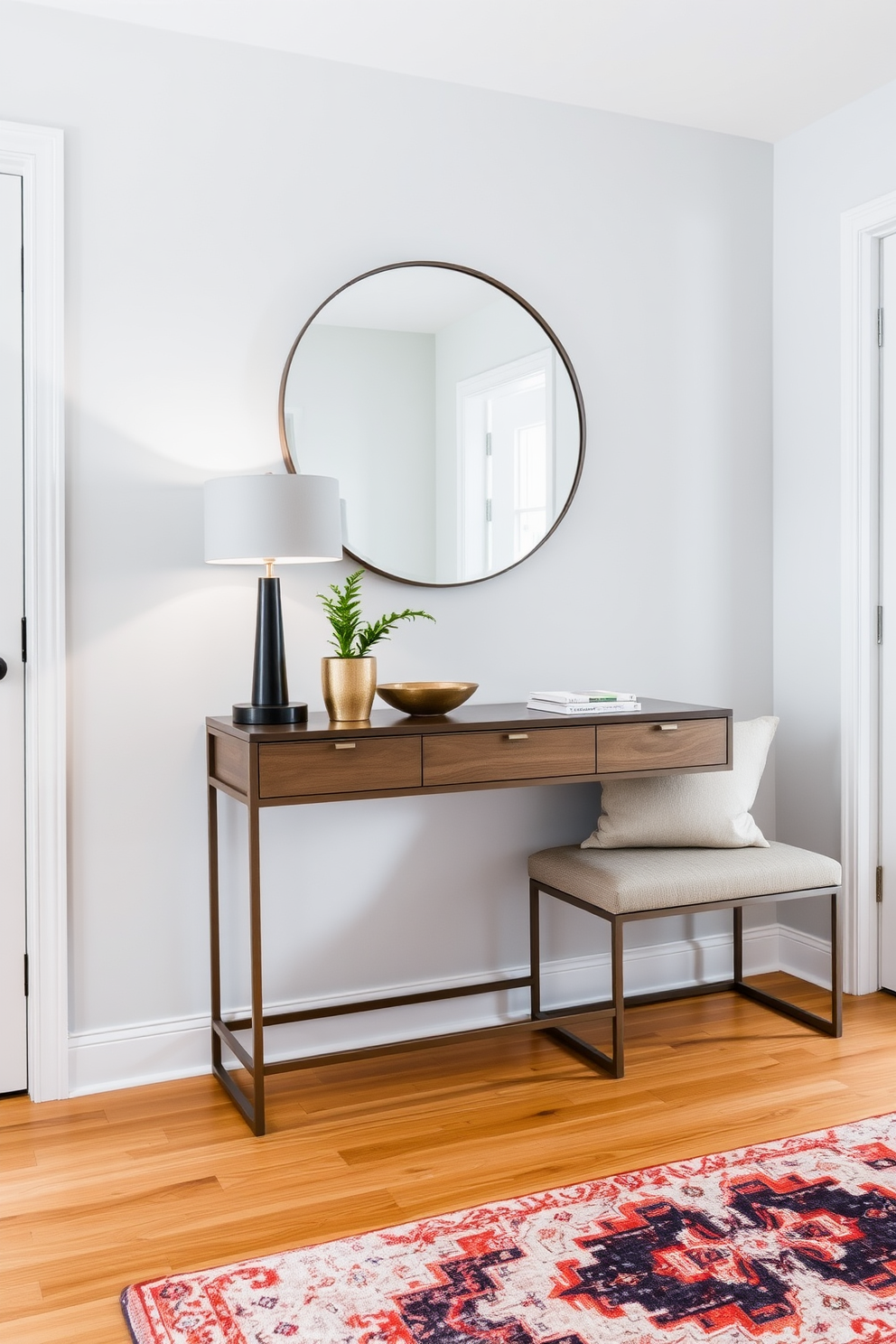 A chic condo entryway featuring a stylish console table against a light gray wall. The console table is adorned with a sleek lamp, a decorative bowl, and a small potted plant, creating an inviting atmosphere. To the side of the console, a modern bench with plush cushions provides seating, while a large round mirror above the table enhances the sense of space. The floor is finished with warm wood tones, complemented by a colorful area rug that adds a touch of personality.