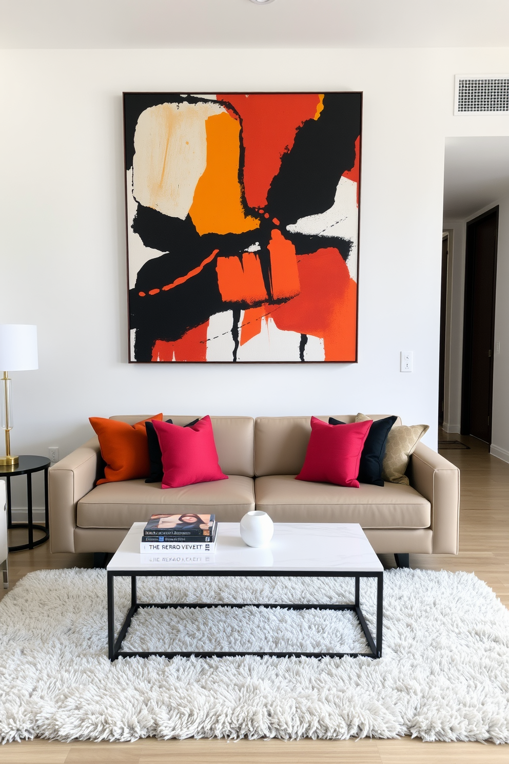 A stylish condo living room featuring a large bold artwork piece as the focal point. The artwork is displayed prominently above a sleek modern sofa, which is adorned with vibrant throw pillows. The walls are painted in a soft neutral tone to enhance the artwork's colors. A contemporary coffee table sits in front of the sofa, complemented by a plush area rug that adds warmth to the space.