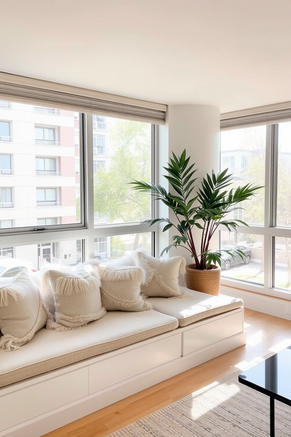 A cozy condo living room features a cushioned window seat adorned with plush throw pillows, inviting relaxation and comfort. Natural light streams in through the large windows, illuminating the soft, neutral color palette of the space.