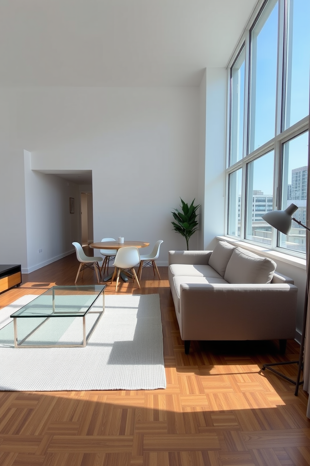 A contemporary apartment features minimalist furniture that emphasizes clean lines and functionality. A sleek, low-profile sofa in a neutral color is complemented by a glass coffee table and a simple area rug that adds warmth to the space. The dining area showcases a round wooden table surrounded by minimalist chairs, creating an inviting atmosphere. Large windows allow natural light to flood the room, enhancing the airy feel of the uncluttered design.