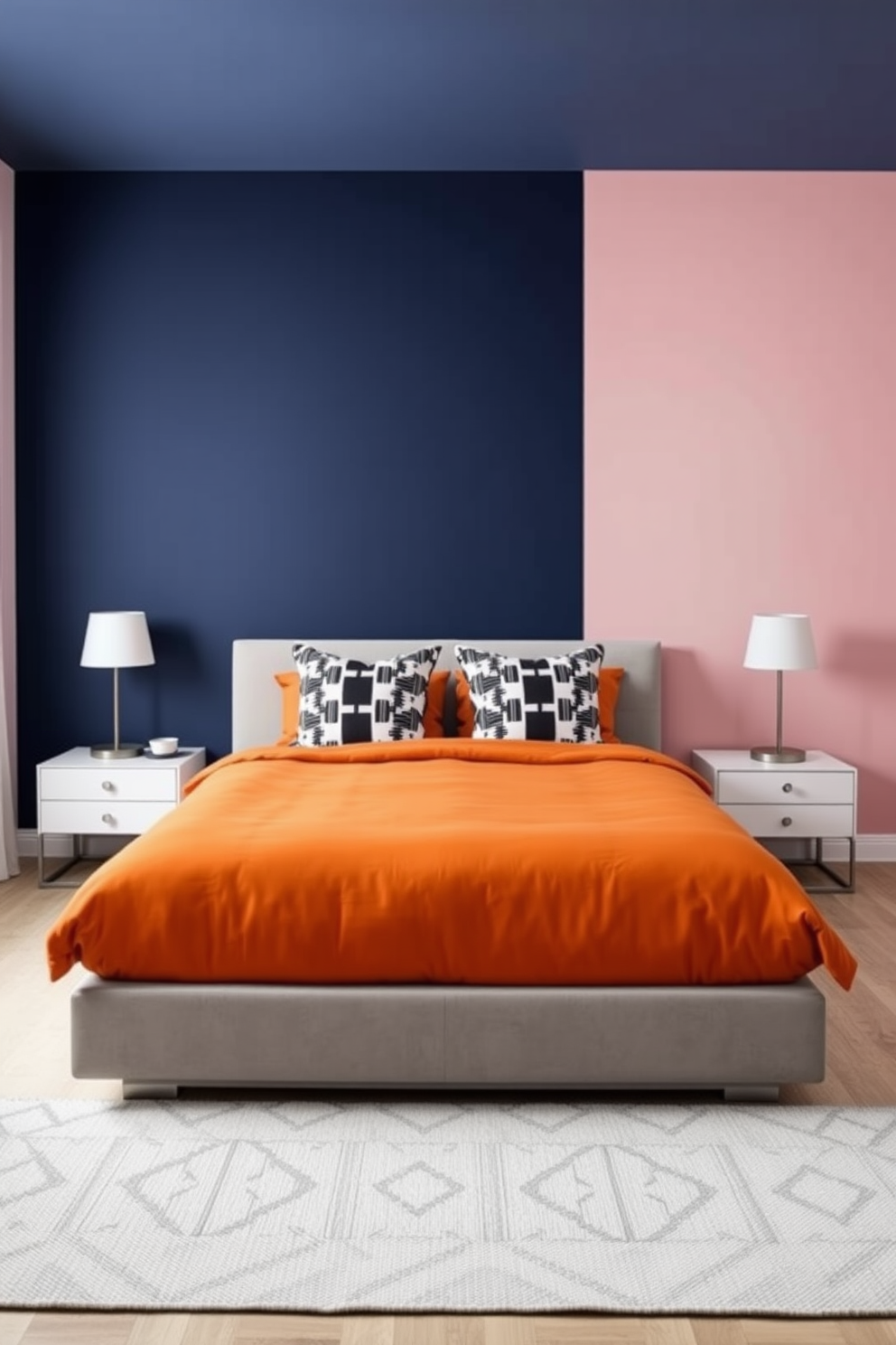 A contemporary bedroom that showcases color-blocking techniques in decor. The walls are divided into bold blocks of color, with one wall painted in a deep navy blue and the opposite wall in a soft blush pink. A sleek platform bed is centered in the room, adorned with a vibrant orange duvet and contrasting black and white patterned pillows. A minimalist nightstand on either side holds modern lamps with geometric shapes, enhancing the room's stylish aesthetic.