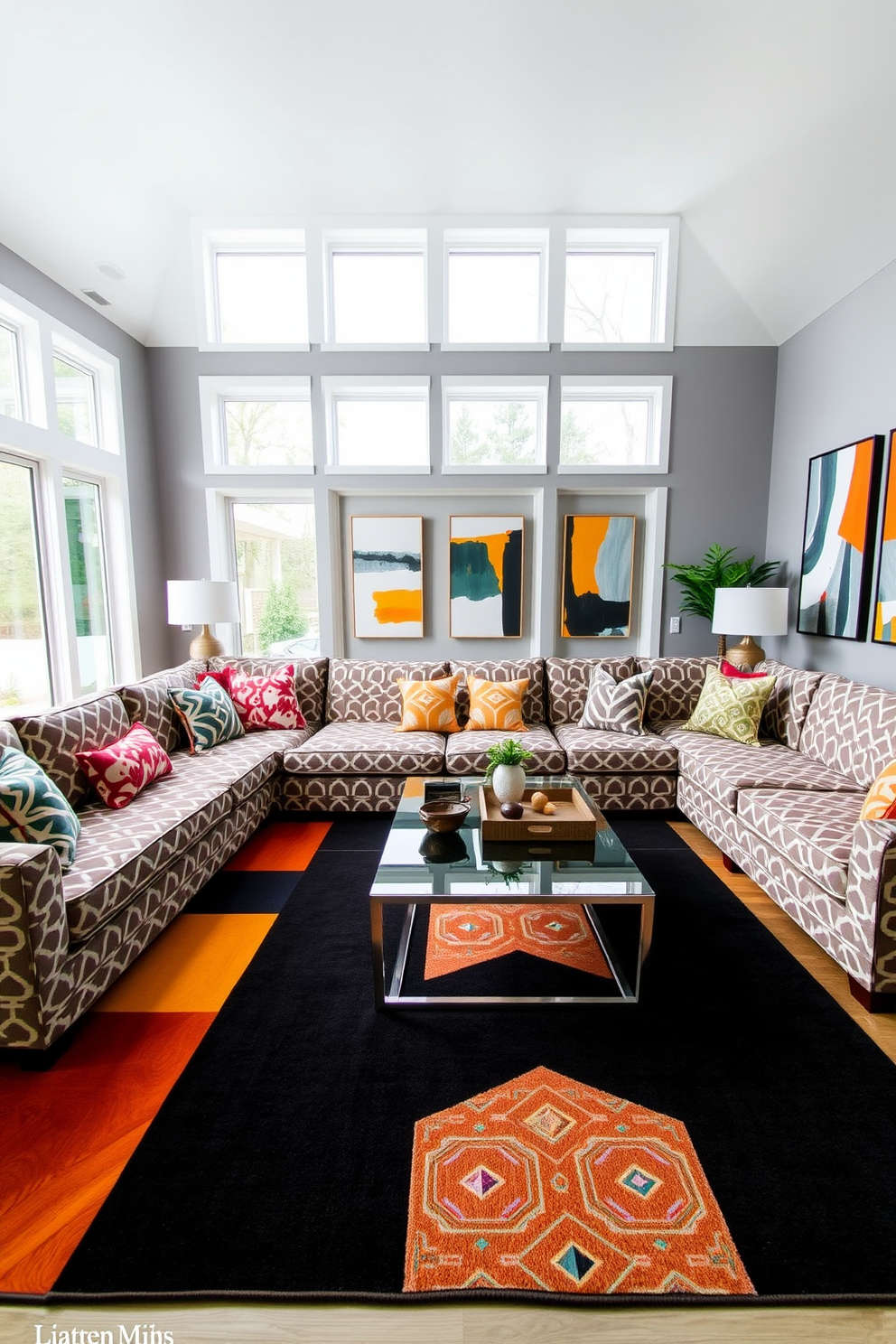 A contemporary family room features an inviting sectional sofa upholstered in a bold geometric pattern. The walls are painted in a soft gray, and a large area rug with contrasting geometric designs anchors the seating area. A sleek coffee table with a glass top sits in the center, surrounded by colorful accent pillows that echo the patterns in the textiles. Floor-to-ceiling windows allow natural light to flood the space, highlighting the modern art pieces displayed on the walls.