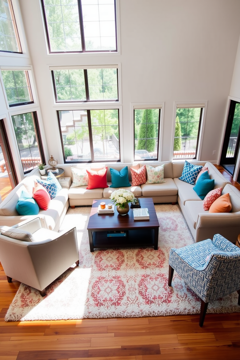 A contemporary family room features a plush sectional sofa adorned with colorful throw pillows in various patterns and textures. Large windows allow natural light to flood the space, enhancing the warm tones of the wooden flooring and soft area rug. A stylish coffee table sits at the center, surrounded by accent chairs that complement the vibrant pillows. The walls are painted in a light neutral shade, creating a cozy atmosphere perfect for family gatherings.