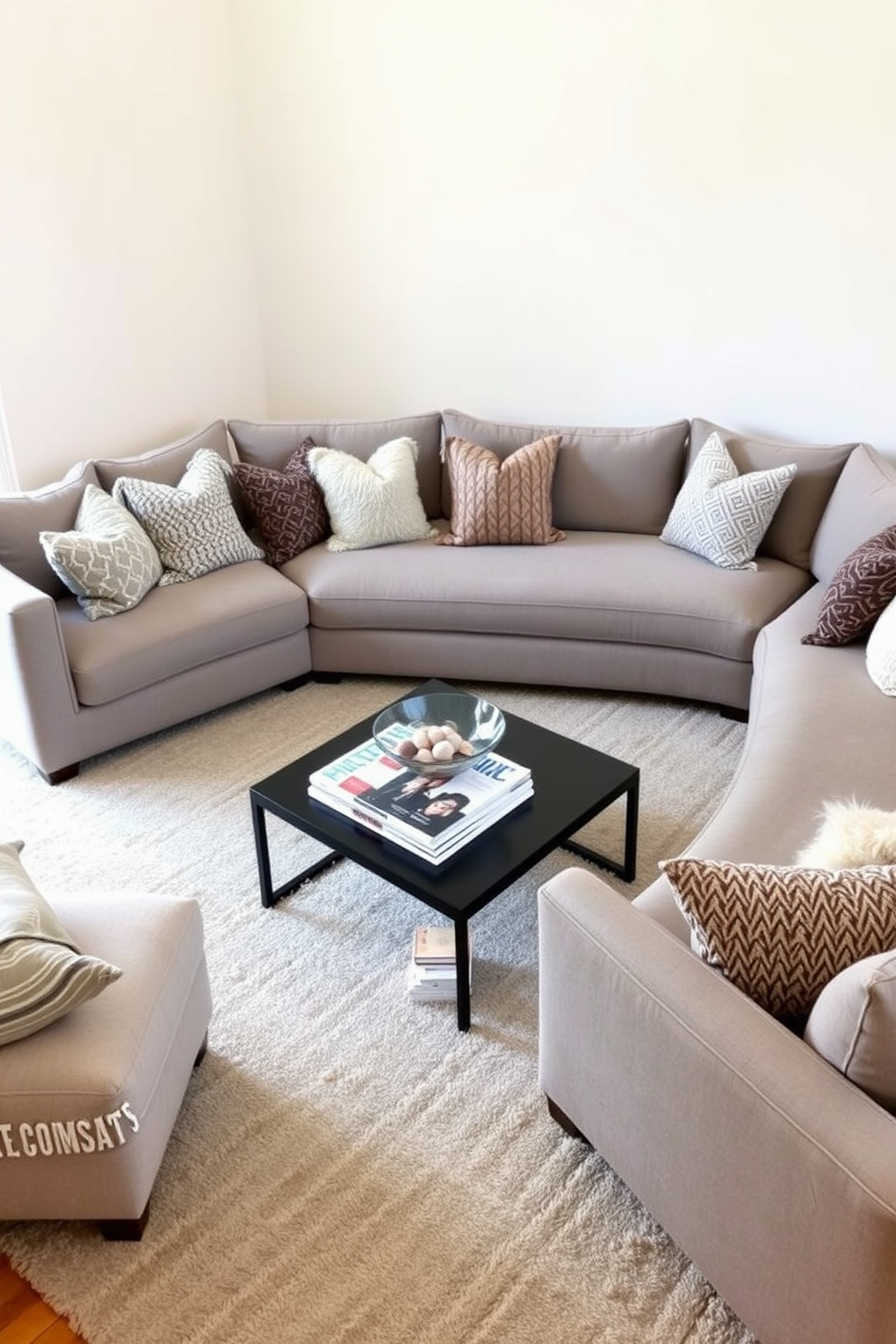 A large sectional sofa in a soft gray fabric dominates the cozy family room, inviting relaxation and conversation. Surrounding the sectional are plush throw pillows in various textures, adding warmth and comfort to the space. The walls are painted in a light beige tone, creating a bright and airy atmosphere. A sleek coffee table in the center holds a stack of design magazines and a decorative bowl, while a stylish area rug anchors the seating arrangement.