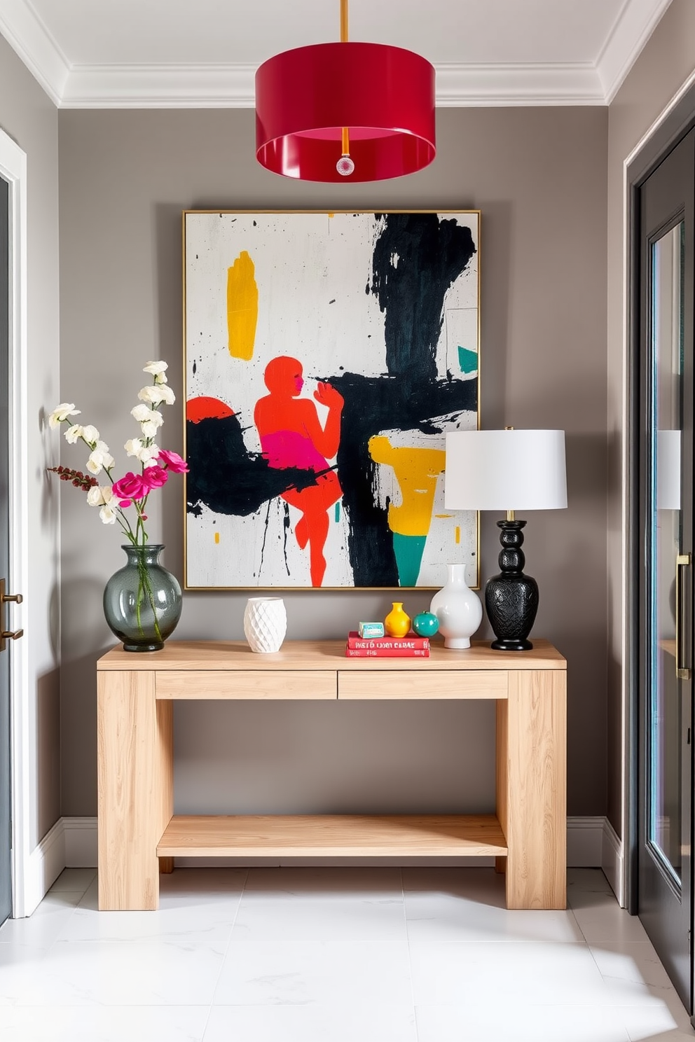 A contemporary foyer featuring neutral tones accented by vibrant pops of color. The space includes a sleek console table in light wood, adorned with a bold abstract painting and a cluster of colorful decorative items.