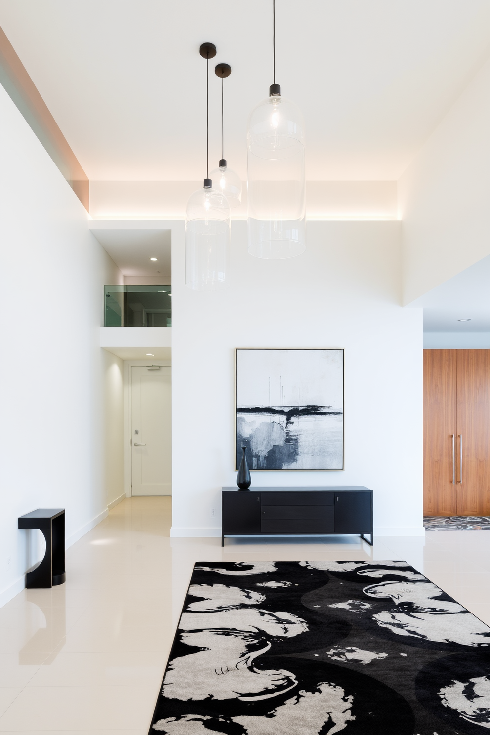 A contemporary foyer features a spacious entryway with sleek lines and a neutral color palette. Suspended from the ceiling, modern pendant lights create visual interest while illuminating the space. The foyer is adorned with a minimalist console table against one wall, complemented by a large abstract art piece above it. A stylish area rug anchors the space, adding warmth and texture to the elegant design.