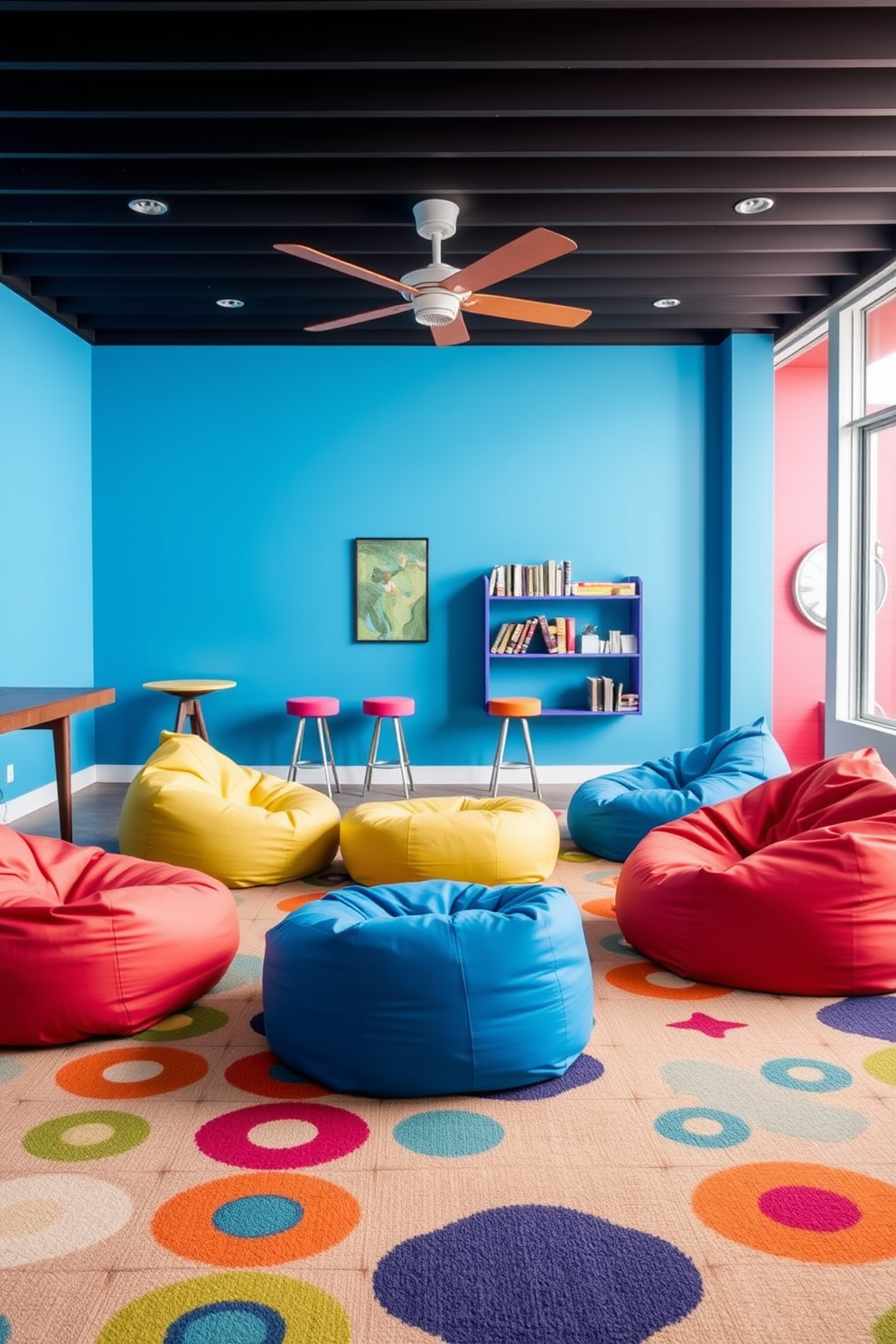 A vibrant game room featuring colorful bean bags arranged for casual seating. The walls are painted in a bright hue, and a large rug with playful patterns anchors the space.