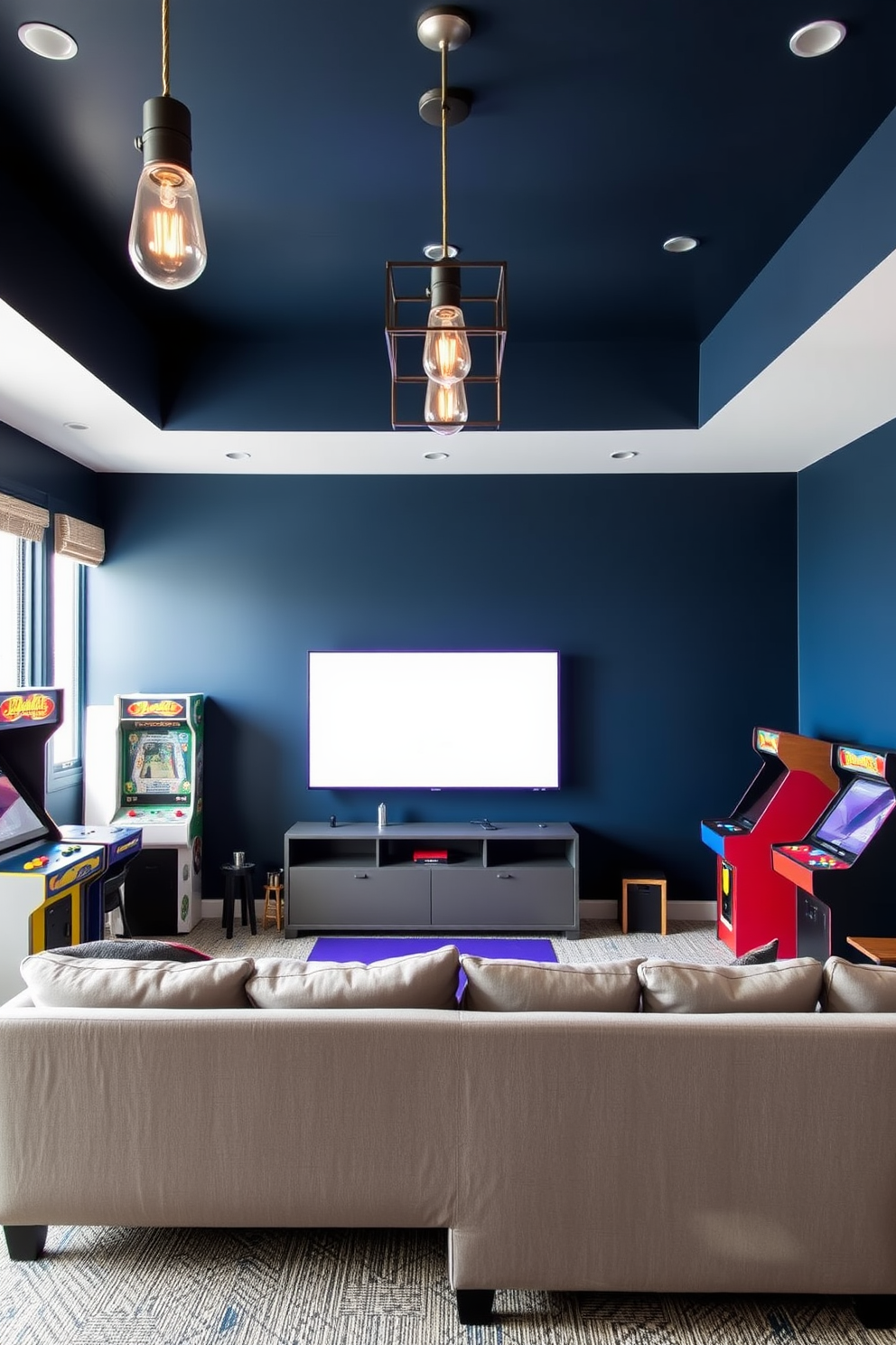 A contemporary game room featuring vintage arcade machines as decor pieces. The walls are painted in a deep navy blue, creating a striking contrast with the colorful arcade machines that line the room. A plush sectional sofa in a light gray hue is positioned in front of a large flat-screen TV. Industrial-style pendant lights hang from the ceiling, providing warm illumination and enhancing the modern aesthetic of the space.