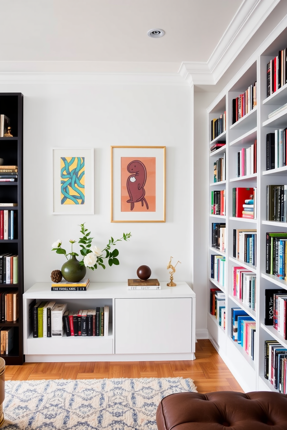 A contemporary home library featuring white walls adorned with vibrant artwork that adds character to the space. The room includes sleek, modern bookshelves filled with an eclectic mix of books and decorative items, creating an inviting atmosphere.