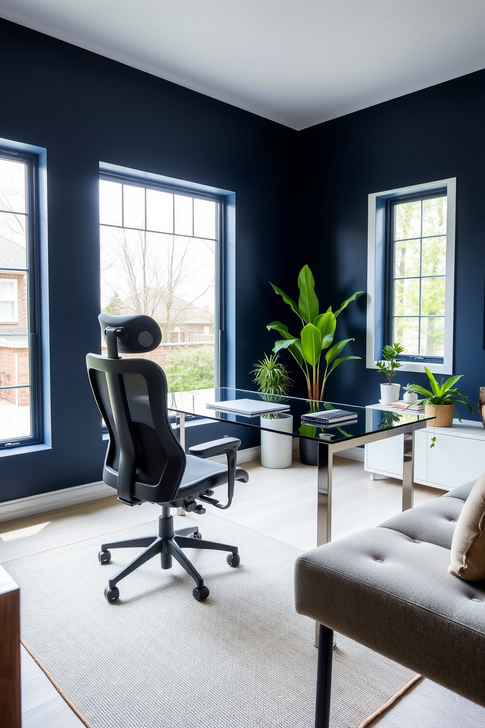 A bold accent wall in a rich navy blue sets the tone for this contemporary home office. The space features a sleek glass desk paired with a stylish ergonomic chair, creating a perfect blend of comfort and modernity. Large windows allow natural light to flood the room, highlighting the minimalist decor. A few potted plants add a touch of greenery, while a geometric rug anchors the seating area.