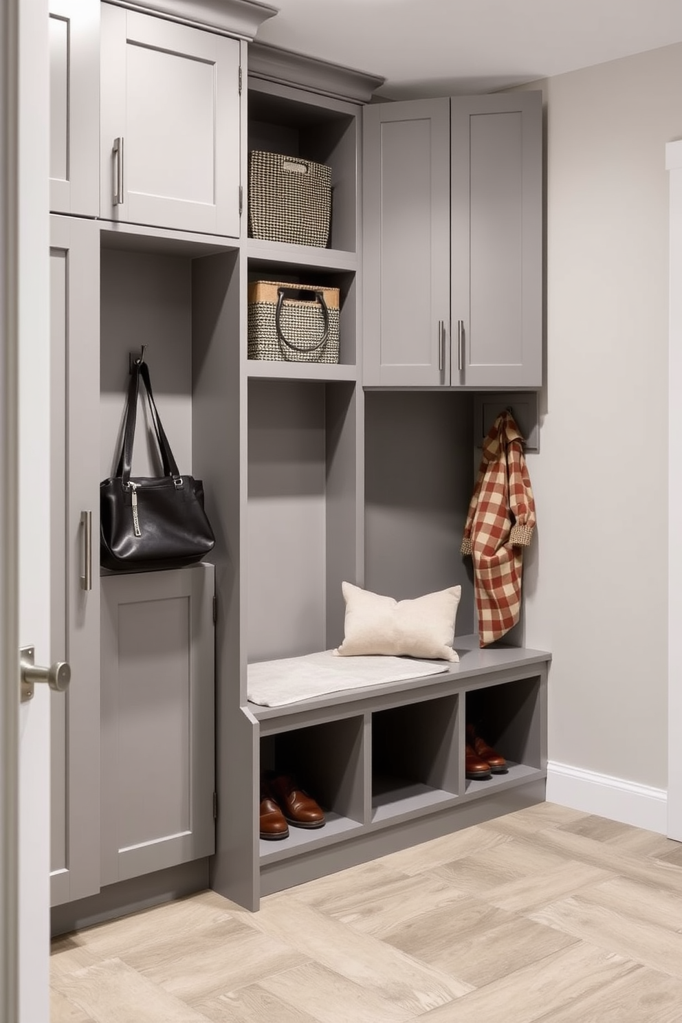 A spacious mudroom features a sleek bench with hidden storage compartments underneath. The walls are adorned with shiplap, and the floor is covered with durable, water-resistant tiles in a neutral tone.