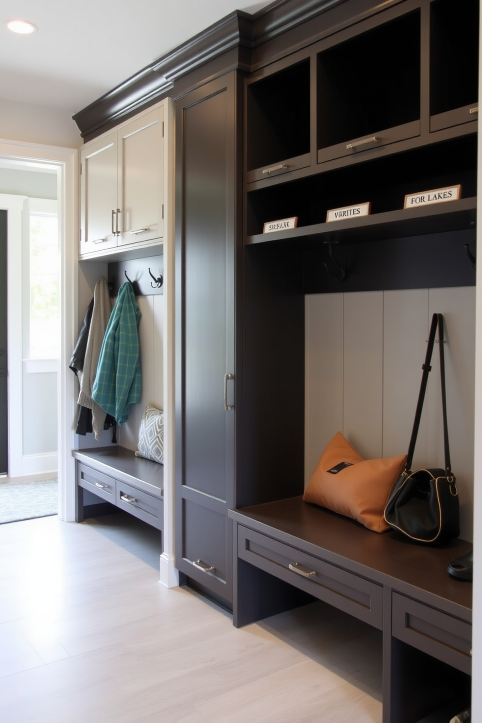 A contemporary mudroom features personalized name tags for each family member's cubby. The space includes built-in storage with sleek cabinetry and a bench, accented by stylish hooks for coats and bags.