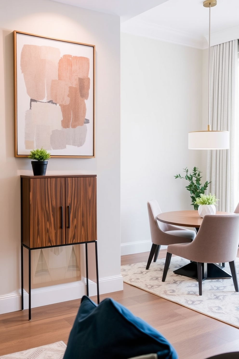 A narrow console table is positioned against the wall, featuring a sleek design with a rich wood finish. Above the table, a large piece of abstract art adds a pop of color to the space, while a small potted plant brings a touch of greenery. In the corner dining room, a round table is surrounded by stylish upholstered chairs that complement the overall decor. Soft lighting from a modern pendant fixture creates an inviting atmosphere, making it perfect for intimate dinners.