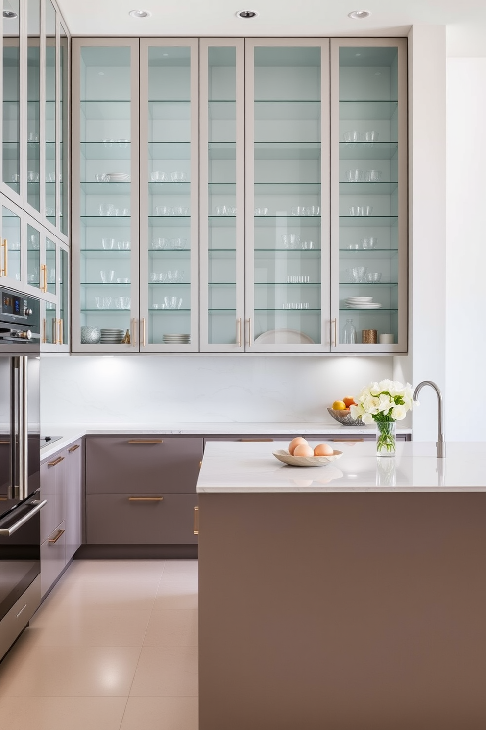 A modern kitchen featuring glass cabinet doors that create an open and airy feel. The cabinetry is sleek and minimalist, allowing for a seamless integration of the kitchen's design elements. The countertops are made of a stunning quartz material that complements the cabinetry. A large island sits in the center, providing ample space for meal preparation and casual dining.