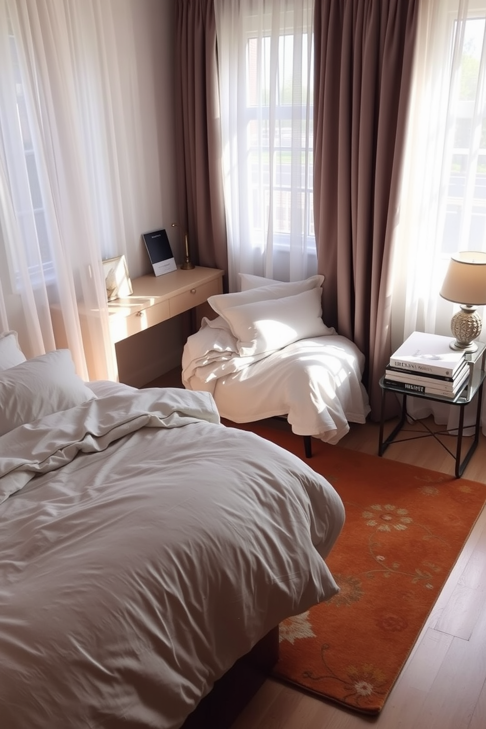 A cozy bedroom setting featuring a small desk tucked into a corner for functionality. The bed is dressed in soft, layered linens with plush pillows, while a warm area rug anchors the space. Natural light filters through sheer curtains, illuminating the room's neutral color palette. A bedside table holds a decorative lamp and a stack of books, adding to the inviting atmosphere.