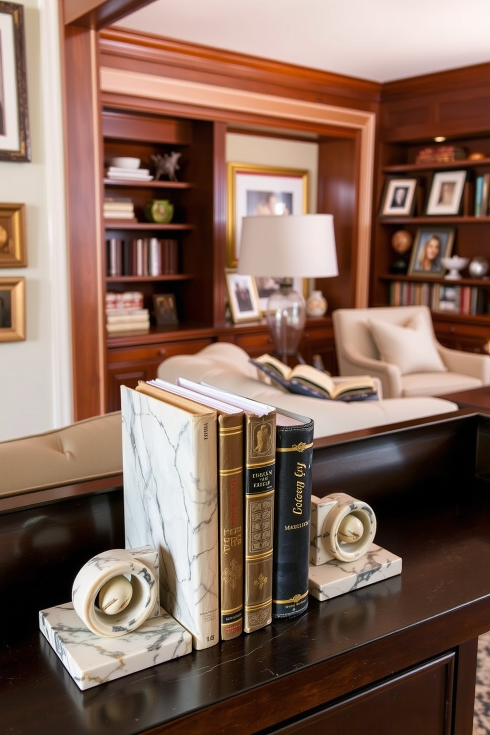 Decorative bookends made of polished marble flank a collection of vintage books on a dark wooden shelf. The bookends feature intricate designs, adding a touch of elegance while keeping the books neatly organized. A cozy home library is adorned with plush seating, soft lighting, and warm wood accents. The space is filled with personal touches, such as framed photographs and a soft area rug, creating an inviting atmosphere for reading.