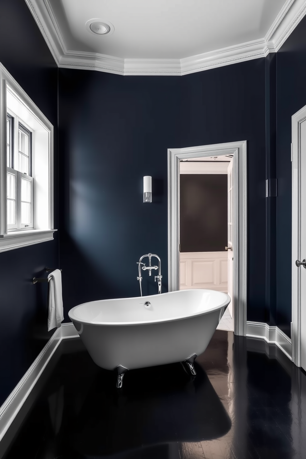 A striking dark bathroom features deep navy walls that create a dramatic backdrop. The bright white trim around the windows and doorways adds a crisp contrast, enhancing the room's elegance. The space is illuminated by sleek, modern fixtures that highlight the rich tones of the walls. A freestanding white bathtub sits against one wall, inviting relaxation amidst the bold color scheme.