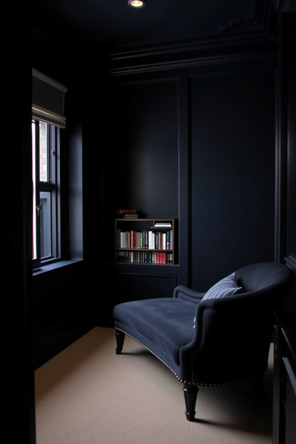 A comfortable chaise lounge is positioned in a cozy reading nook nestled in the corner of a dark study room. The walls are painted in a deep navy blue, creating an intimate atmosphere, while a small bookshelf filled with books adds a touch of warmth to the space.