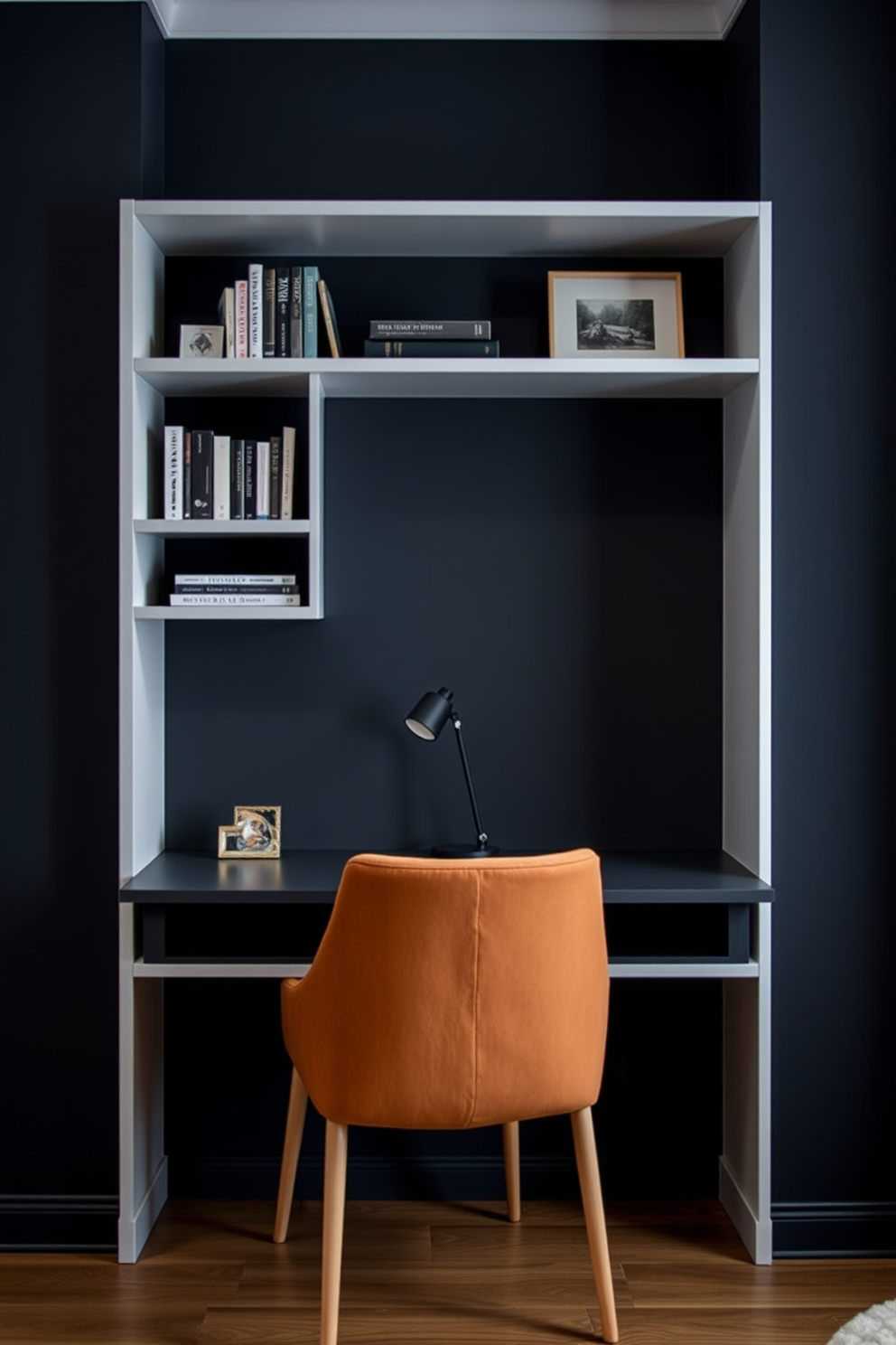 A sleek wall-mounted desk is positioned against a dark, moody backdrop, creating a perfect space-saving solution. The desk features clean lines and a minimalist design, complemented by stylish shelves above for books and decor. The room is enveloped in deep shades of charcoal and navy, enhancing the cozy atmosphere. A plush armchair in a contrasting color provides a comfortable reading nook beside the desk.