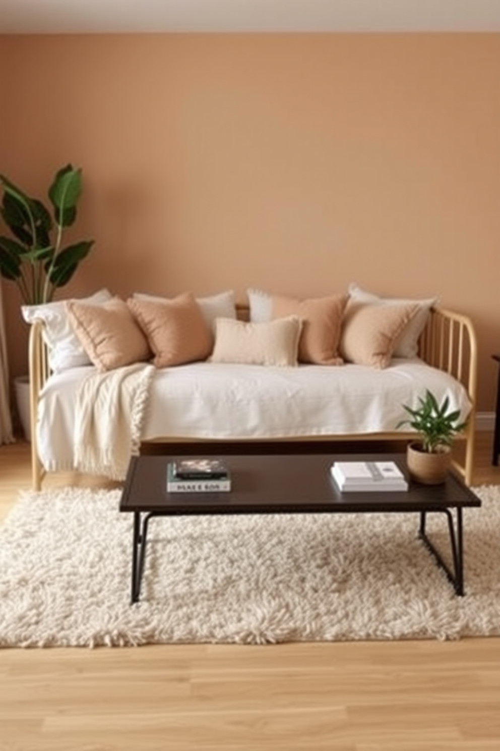 A cozy living room setting with a daybed adorned with plush cushions and a soft area rug beneath it. The walls are painted in a warm neutral tone, and a stylish coffee table sits in front of the daybed, complemented by a few decorative books and a small plant.