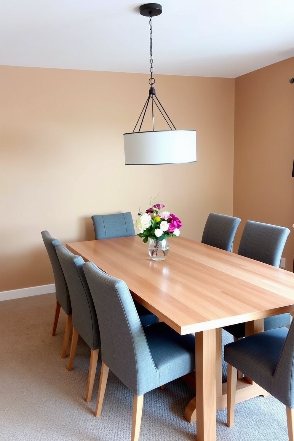 A sleek acrylic dining table is the centerpiece of a modern dining room. Surrounding the table are contemporary chairs with clean lines and vibrant upholstery, creating a striking contrast. The table is set against a backdrop of minimalist artwork on the walls. Soft pendant lighting hangs above, casting a warm glow over the elegant setting.