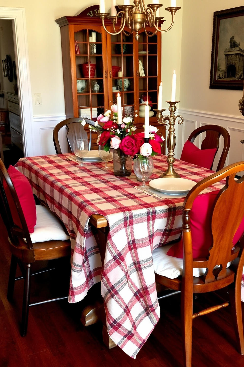 A cozy dining room setting features a warm plaid tablecloth draped over a rustic wooden table. Surrounding the table are mismatched chairs that add charm, with soft cushions in shades of red and cream for comfort. Adorning the table are delicate floral arrangements in vintage vases, enhancing the romantic ambiance for Valentine's Day. Soft candlelight flickers from elegant candlesticks, creating a welcoming atmosphere perfect for intimate gatherings.