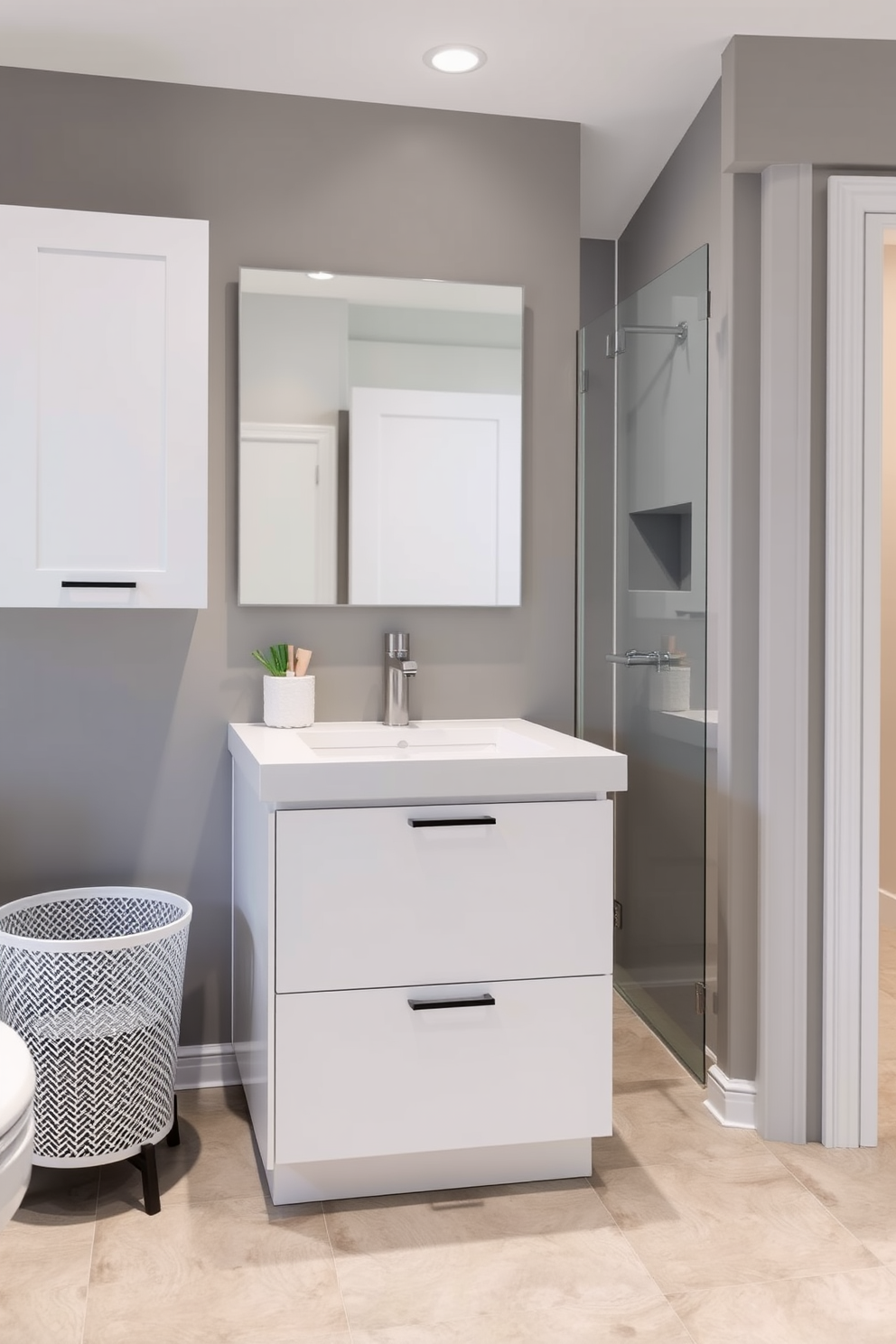 A luxurious bathroom featuring a spacious walk-in shower with a sleek rain showerhead. The walls are adorned with large, glossy white tiles that create a bright and airy atmosphere. Incorporate a floating vanity with a minimalist design for easy cleaning and a clutter-free look. Use non-slip tiles in a soft gray tone for the floor to enhance both safety and style.