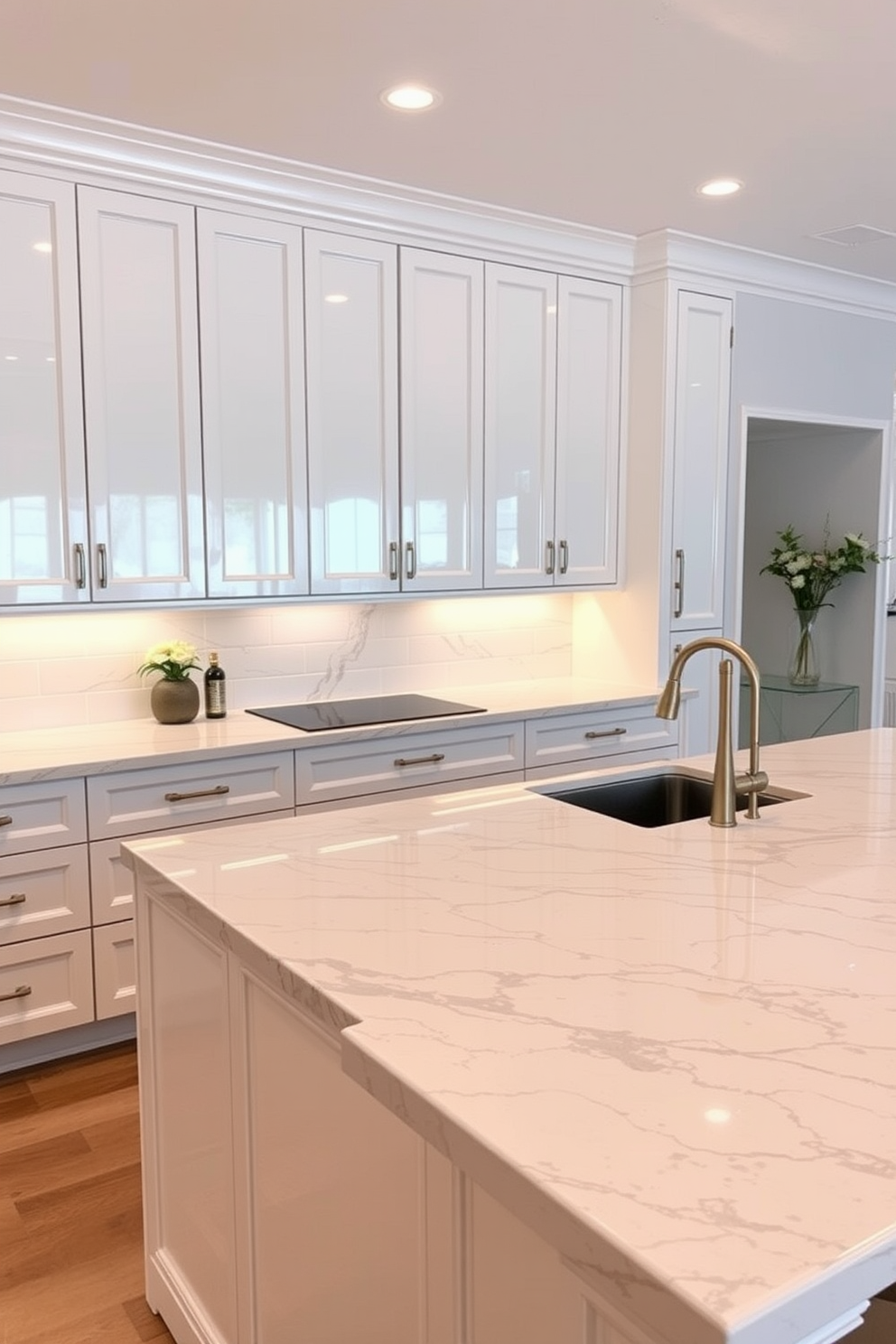 A sleek kitchen featuring marble countertops with waterfall edges that cascade gracefully to the floor. The cabinetry is a soft white with gold hardware, and the backsplash consists of glossy subway tiles for a timeless look.