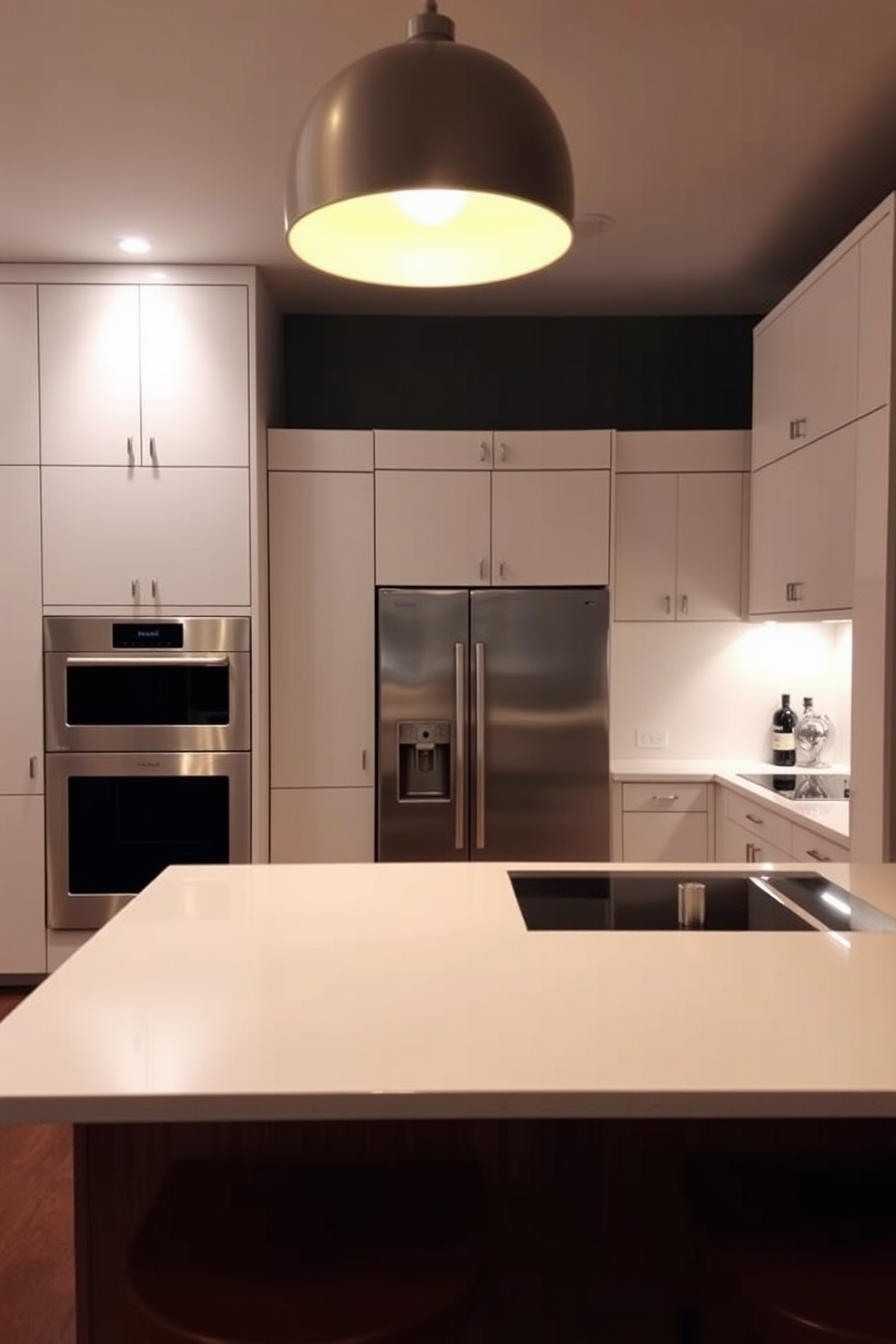 Elegant dining table in the kitchen space. The table is made of dark wood with a polished finish and is surrounded by upholstered chairs in a soft cream fabric. Above the table, a modern chandelier with warm lighting creates an inviting atmosphere. The kitchen features sleek cabinetry in a light gray tone, complemented by a marble backsplash and stainless steel appliances.