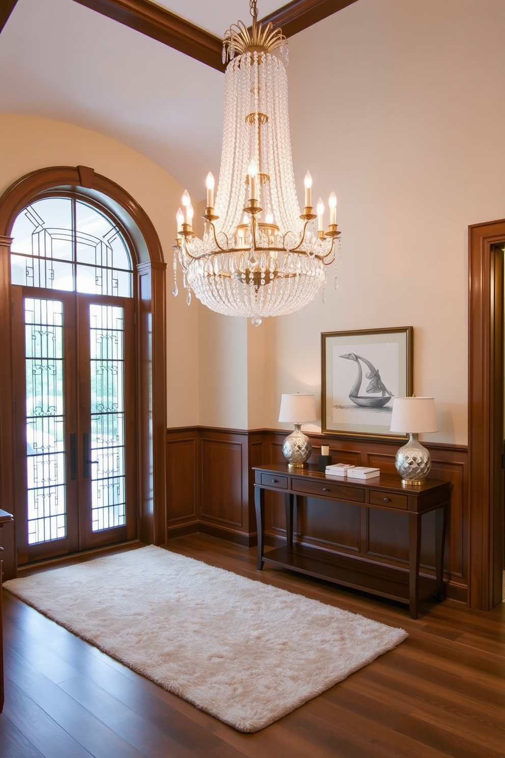 Elegant chandelier for touch of luxury. The entrance foyer features a grand chandelier with crystal accents that casts a warm glow throughout the space. Rich wood paneling lines the walls, complemented by a plush area rug in soft neutral tones. An inviting console table adorned with decorative objects welcomes guests as they enter.