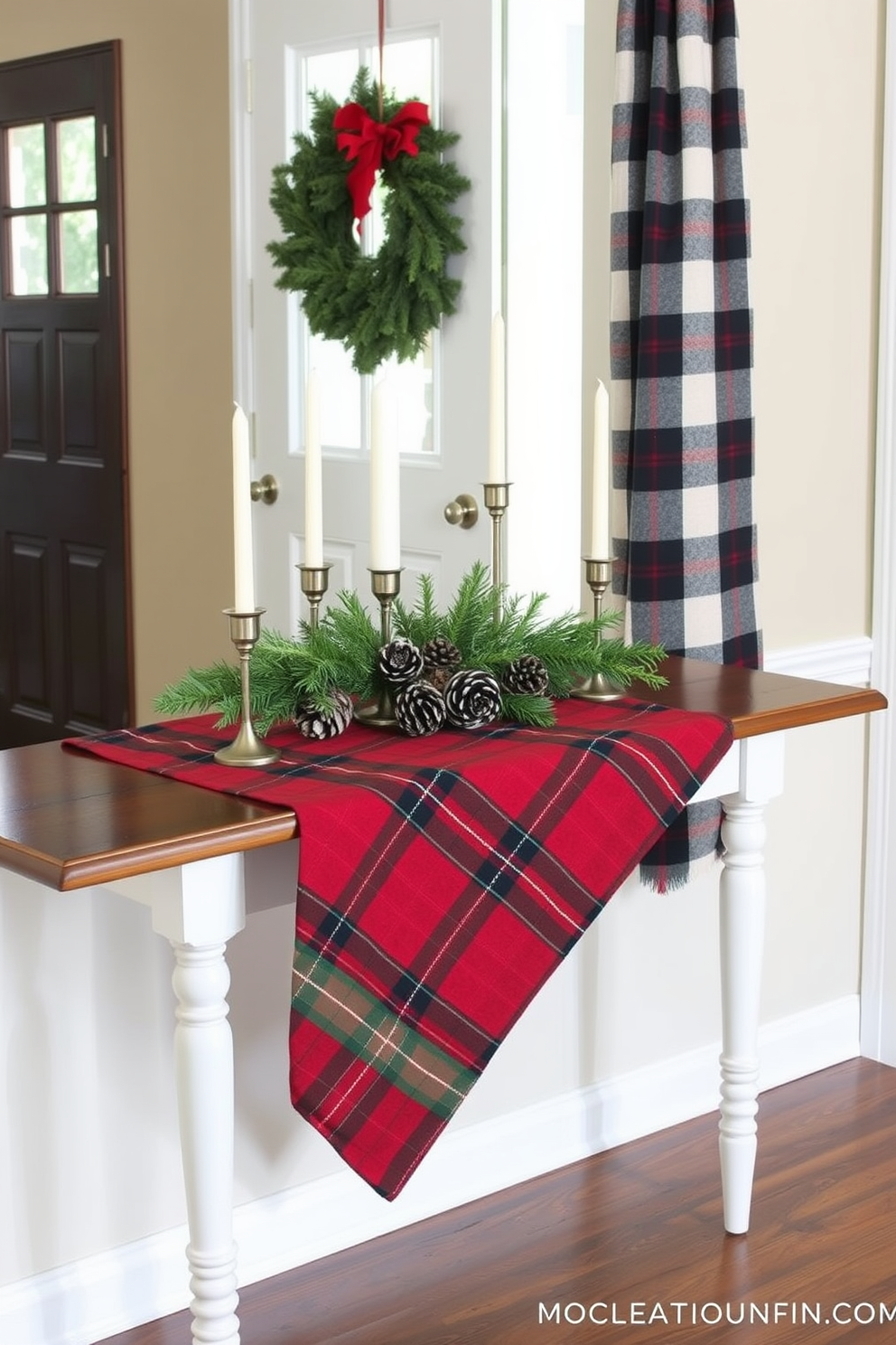 A festive entryway adorned with a red and green plaid runner draped elegantly across a wooden table. The table is decorated with a collection of pinecones, candles, and a small evergreen arrangement, creating a warm holiday welcome.