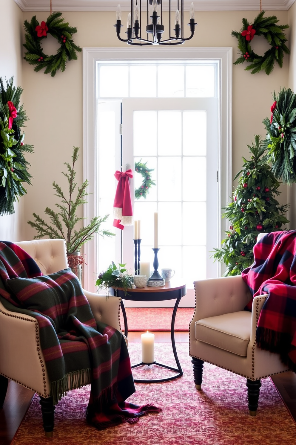 A cozy entryway adorned for the holidays. Festive throw blankets in rich reds and greens are elegantly draped over stylish chairs, inviting warmth and comfort. The walls are decorated with wreaths made of pine and berries. A small table displays a collection of candles and seasonal decorations, creating a welcoming atmosphere.