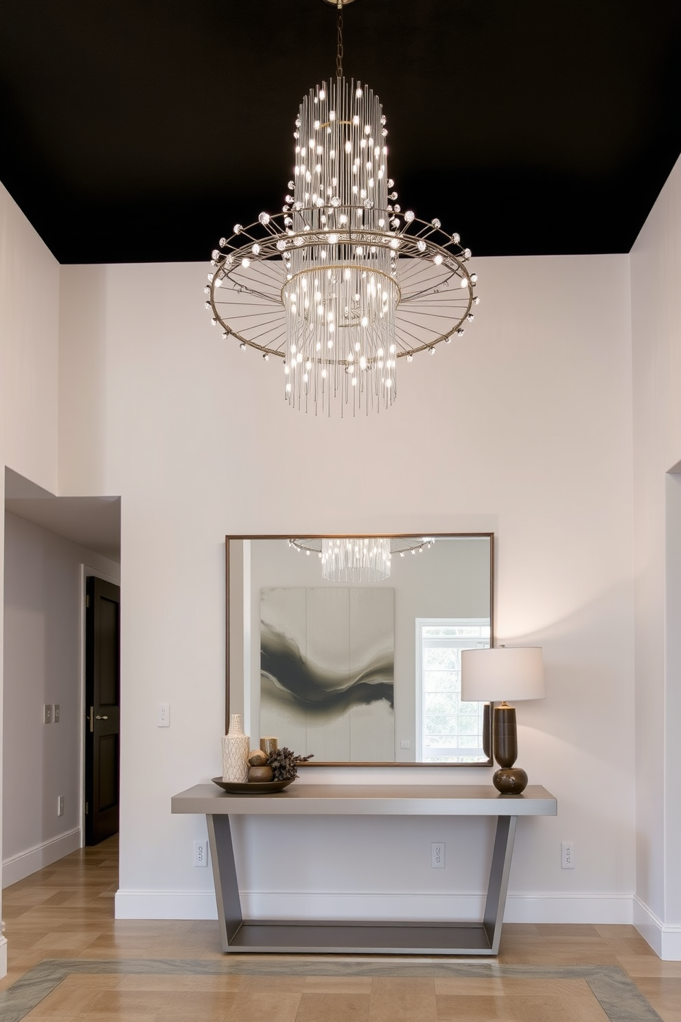 A striking statement lighting fixture hangs from the ceiling, featuring an intricate design that captures attention as soon as one enters the space. The entryway is adorned with a sleek console table, topped with decorative accents and a large mirror that enhances the sense of openness and light.