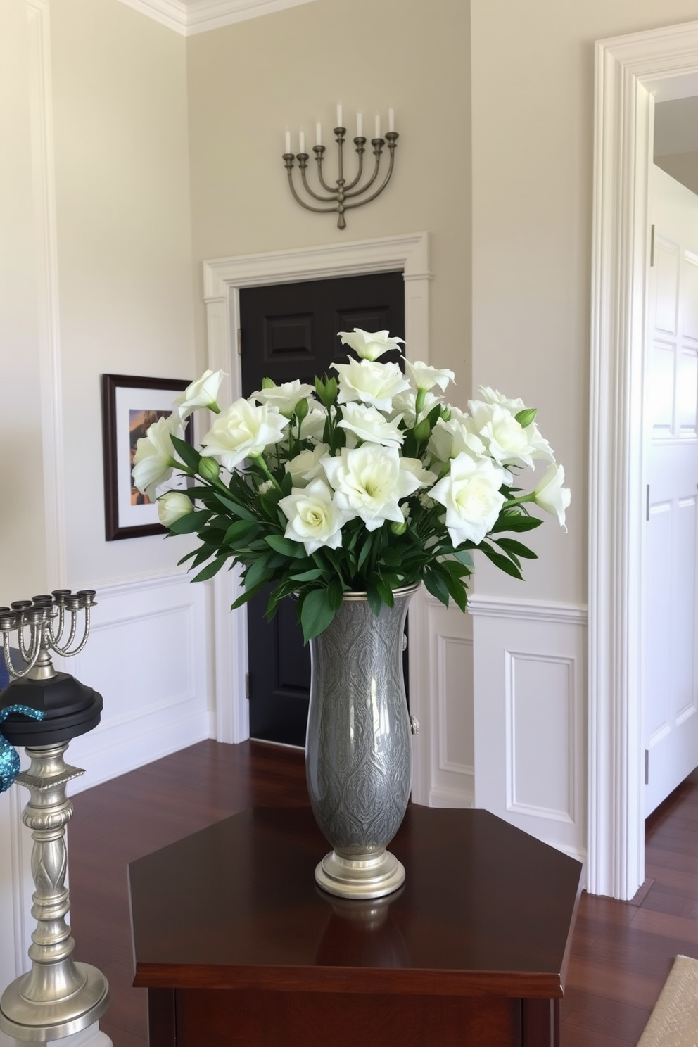 An elegant entryway features a beautifully crafted vase filled with fresh white flowers. The space is adorned with subtle Hanukkah decorations, including a tasteful menorah and shimmering blue and silver accents.