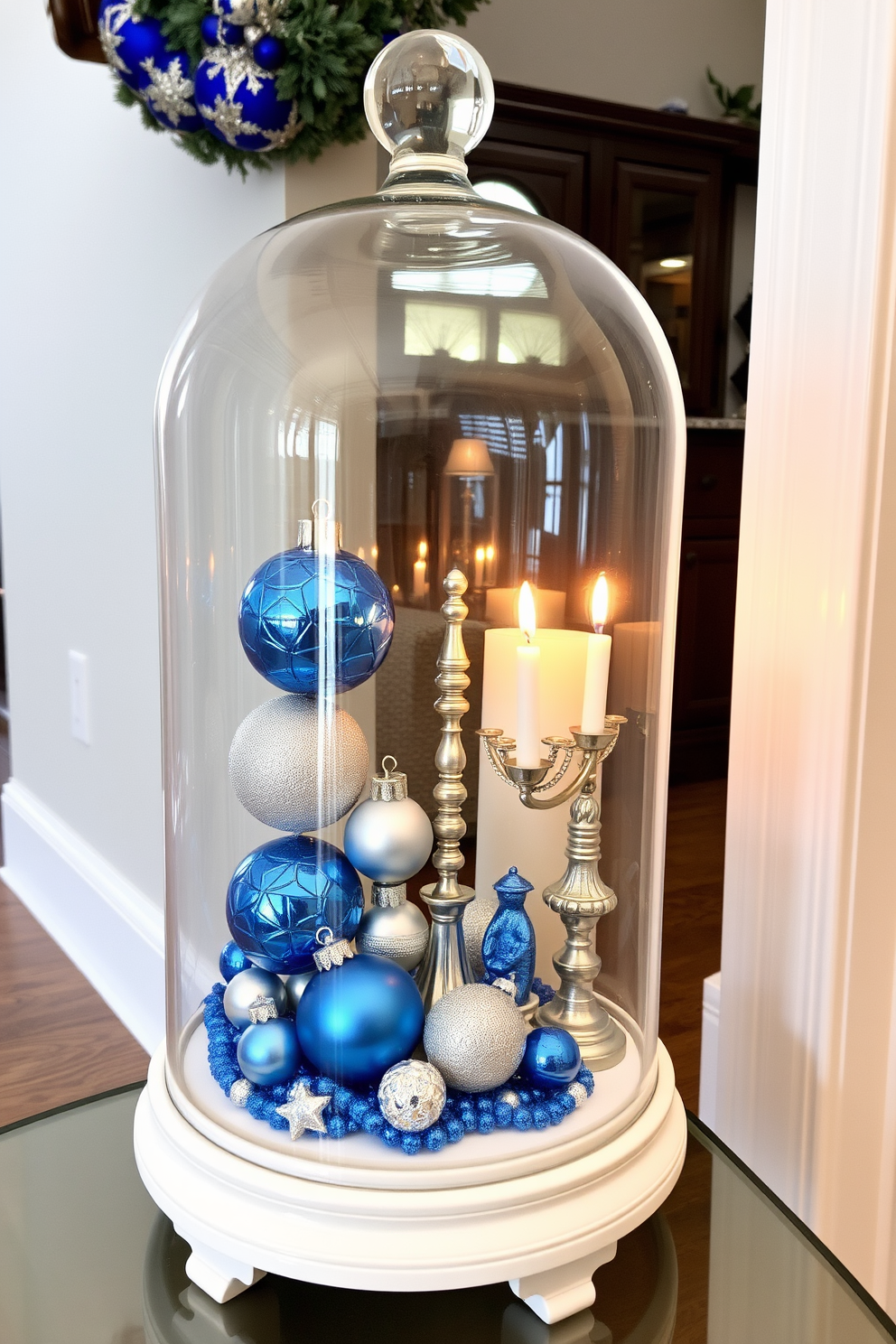 A glass cloche sits elegantly in the entryway, showcasing a vibrant display of Hanukkah decorations. Inside the cloche, blue and silver ornaments, menorah figurines, and festive candles create a warm and inviting atmosphere.