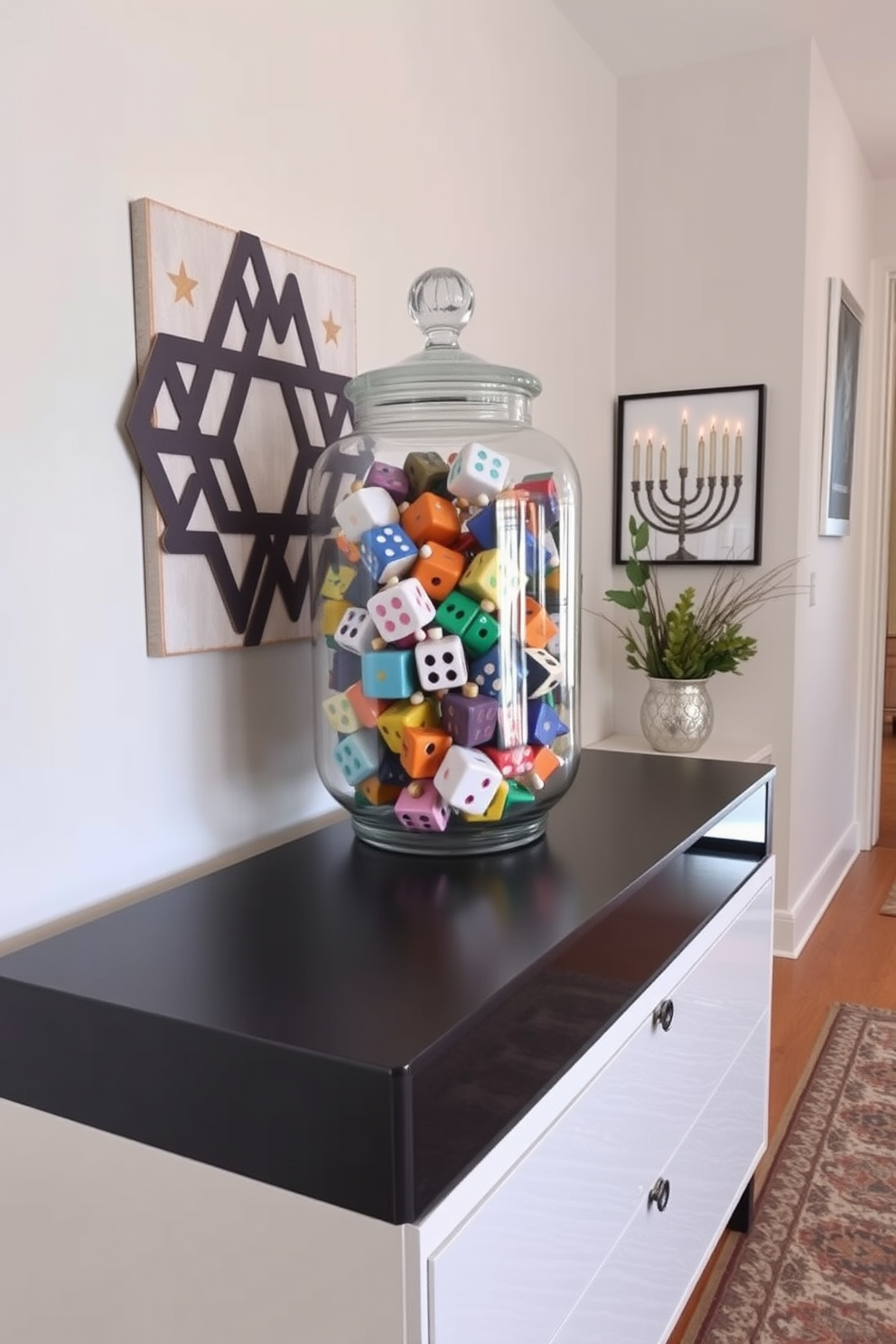 A stylish entryway features a large glass jar filled with colorful decorative dreidels, showcasing a mix of traditional and modern designs. The jar is placed on a sleek console table, complemented by a warm, inviting rug and festive Hanukkah-themed wall art.