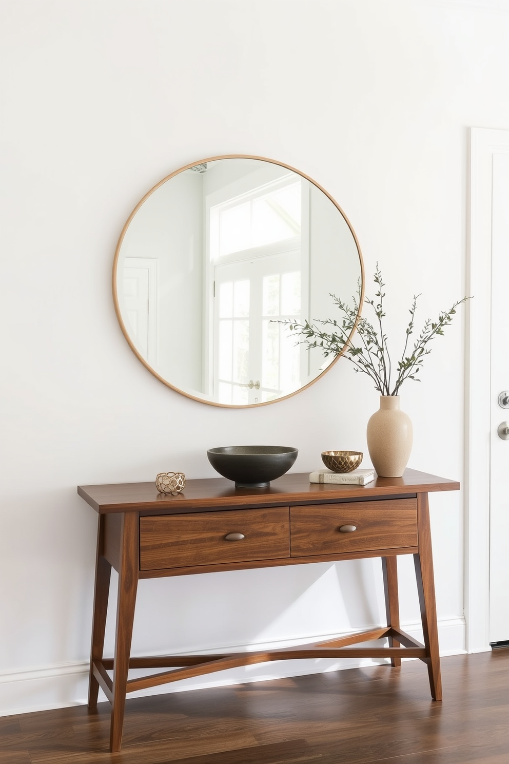 A stylish entryway table is adorned with a large round mirror that reflects natural light. The table features a sleek design in a rich wood finish, complemented by decorative elements like a small potted plant and a decorative bowl.