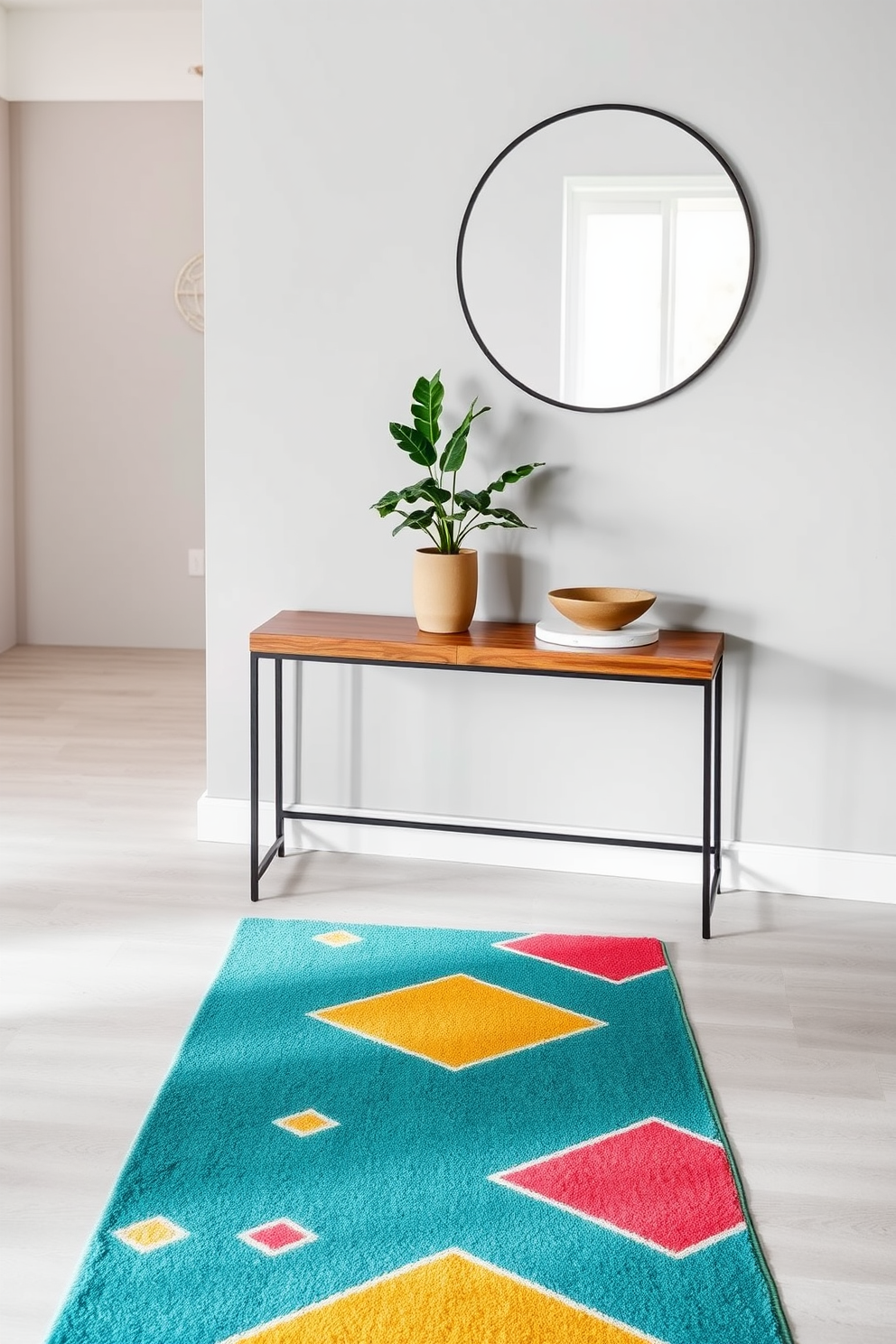 A stylish runner stretches across the entryway floor, featuring vibrant geometric patterns in shades of teal, coral, and mustard. The runner complements a sleek, modern entryway table made of polished wood, adorned with a small potted plant and a decorative bowl. The table is positioned against a soft gray wall, enhancing the overall aesthetic of the space. Above the table, a round mirror with a thin black frame reflects natural light, creating an inviting atmosphere.